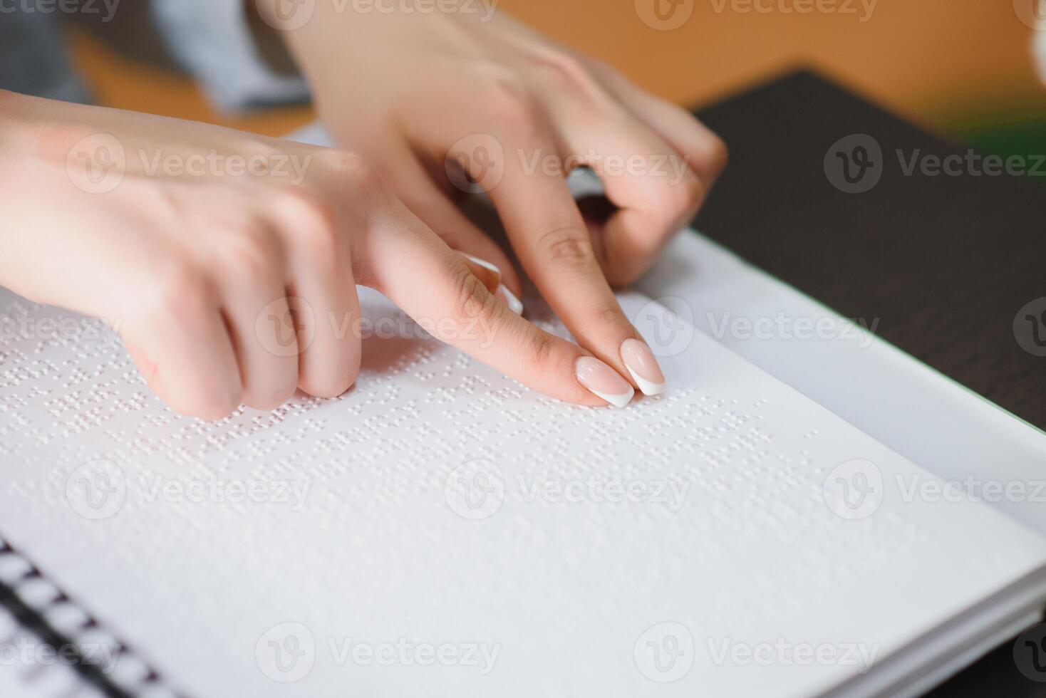 Blind woman read book written in Braille photo