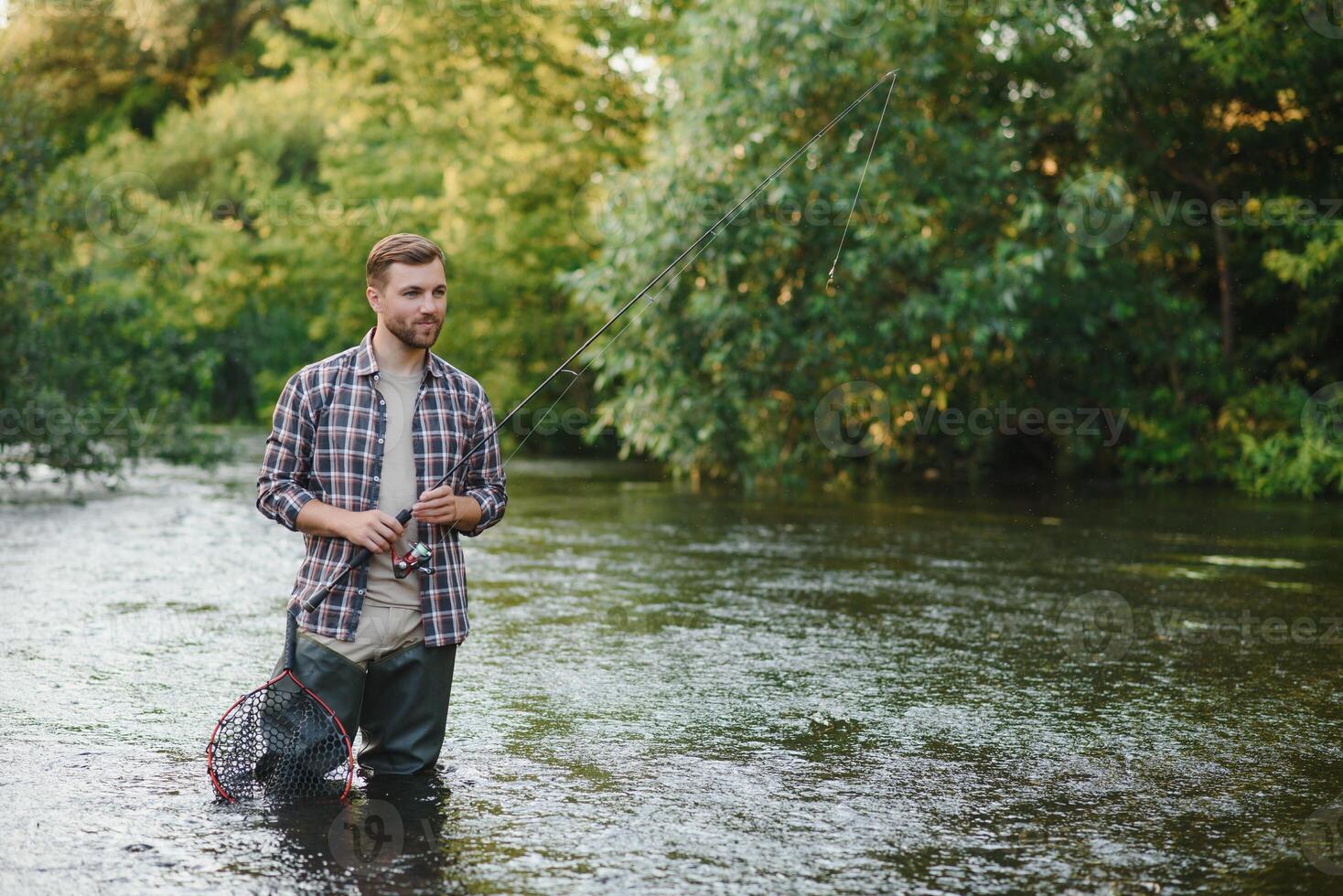 Young man flyfishing at sunrise photo