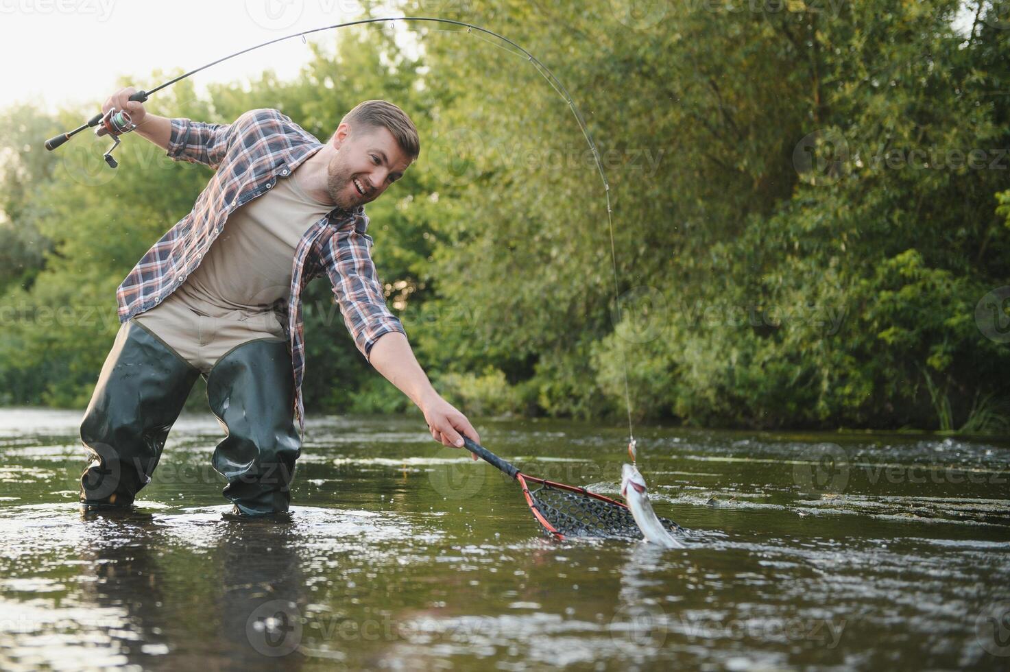 Trout fishing on mountain river photo