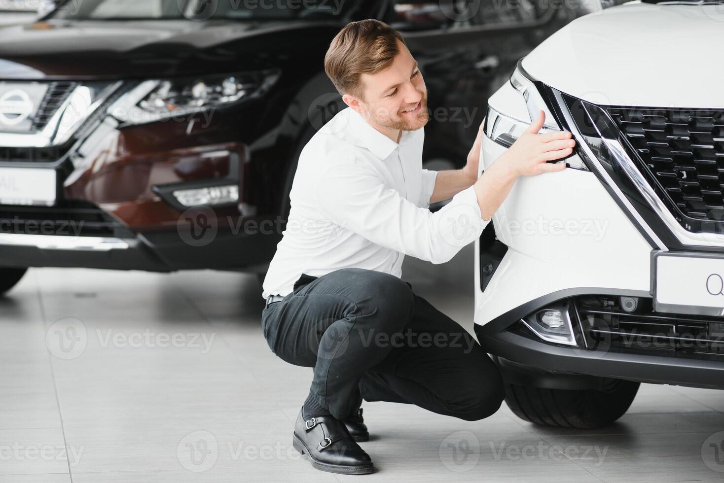 Man adult customer male buyer client chooses auto wants to buy new automobile touch check car in showroom vehicle salon dealership store motor show indoor. Sales concept photo