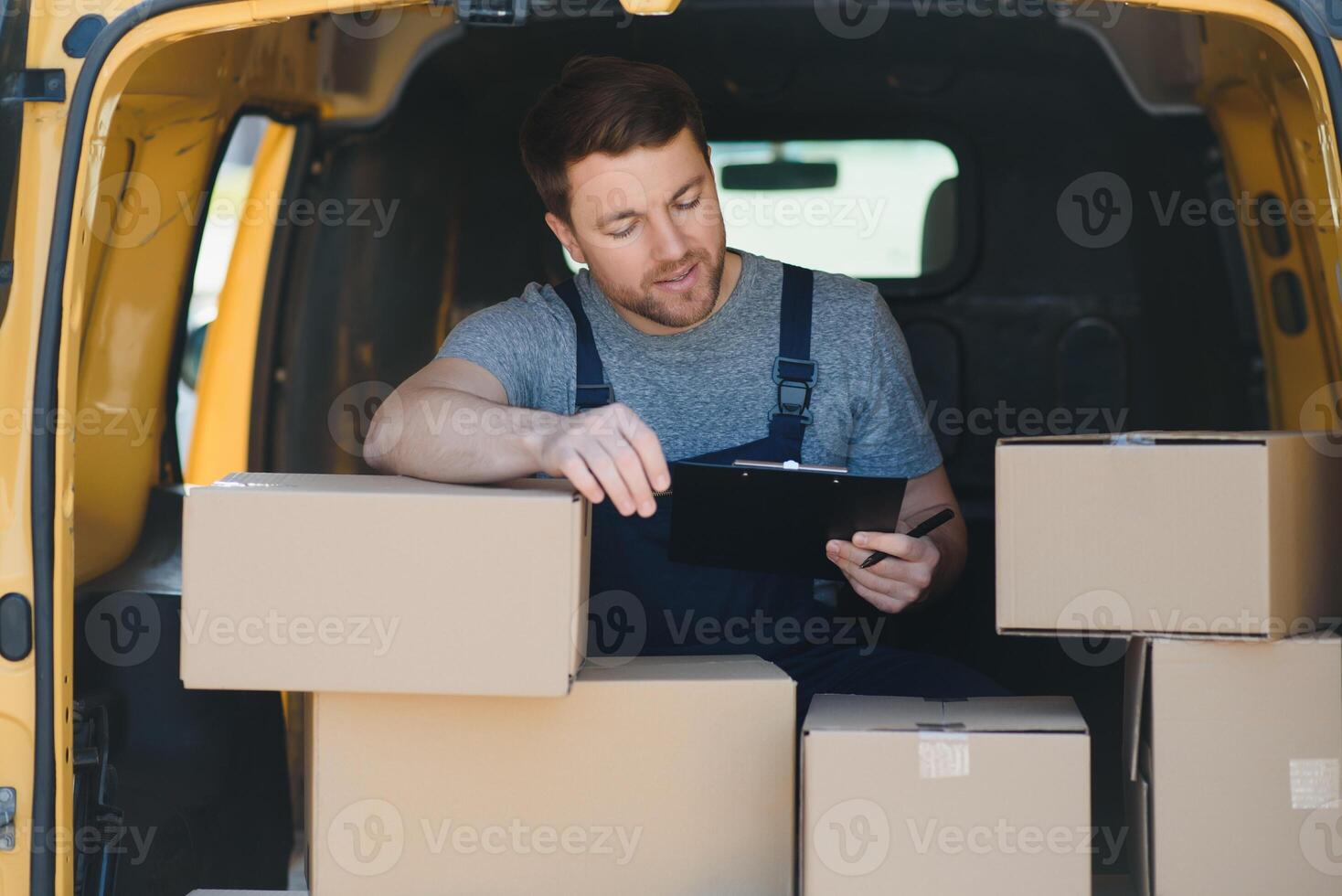 joven entrega hombre mensajero en uniforme sostener documentos portapapeles comprobación lista paquete o empaquetar enviar cajas cerca un coche para Servicio envío a cliente, en línea compras Servicio conceptos. foto