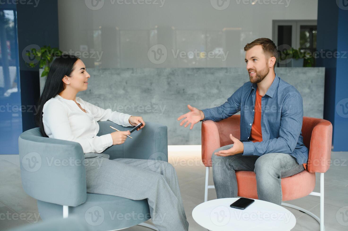 Business concept. Young dark-haired woman sitting in front of mature cheerful office manager on job interview, having relaxing talk about her experience and study degree. photo