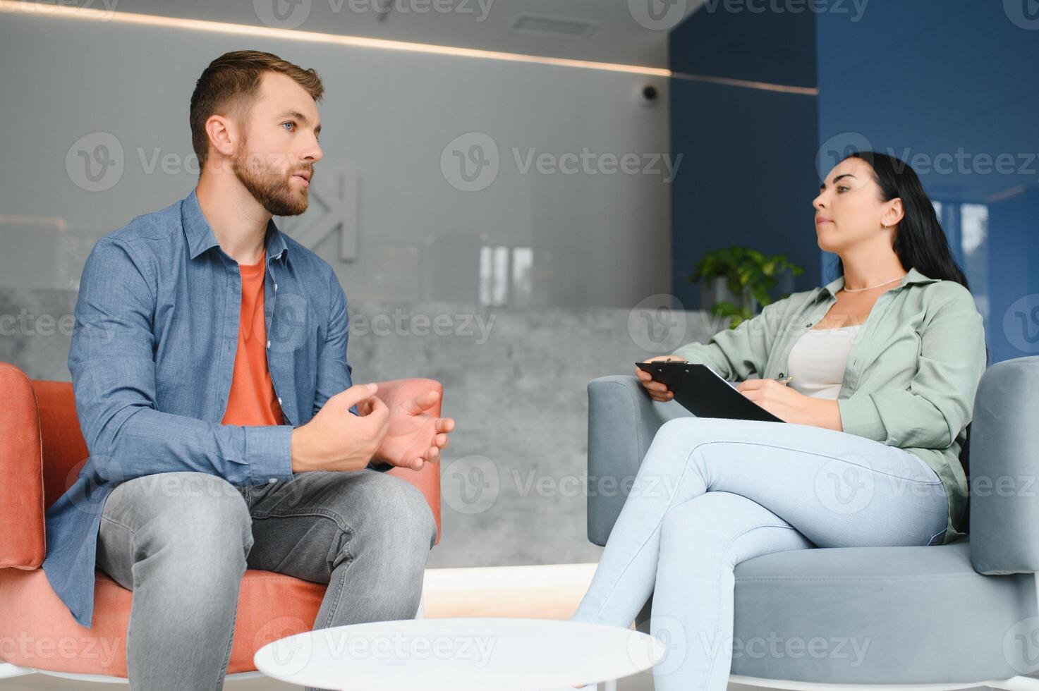 Business concept. Young dark-haired woman sitting in front of mature cheerful office manager on job interview, having relaxing talk about her experience and study degree. photo