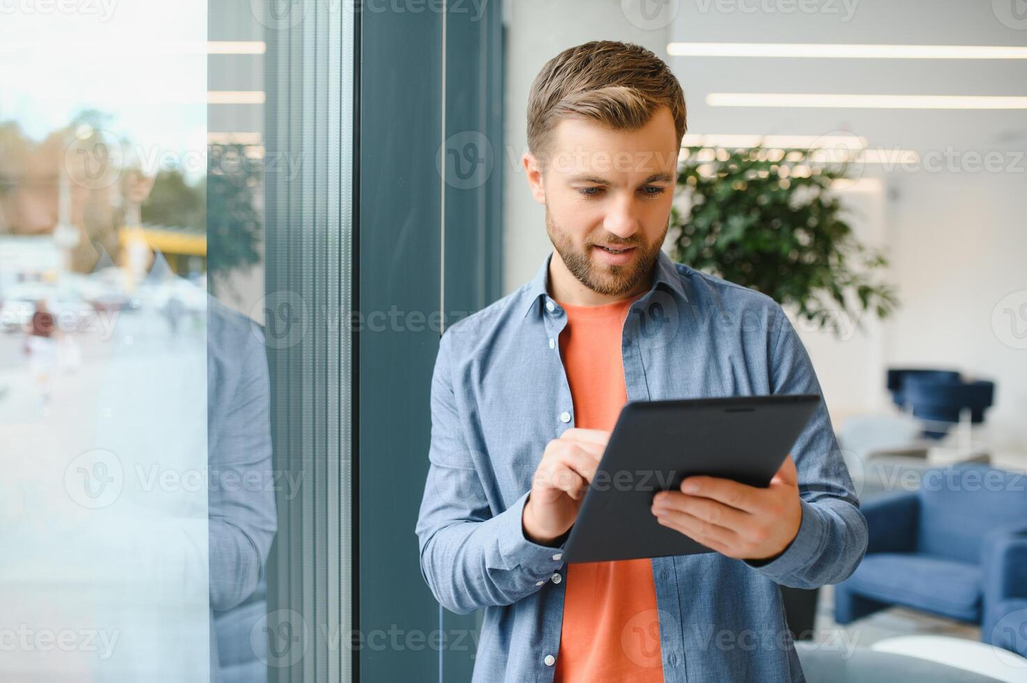 a freelancer man works with a tablet in a work coaching office photo