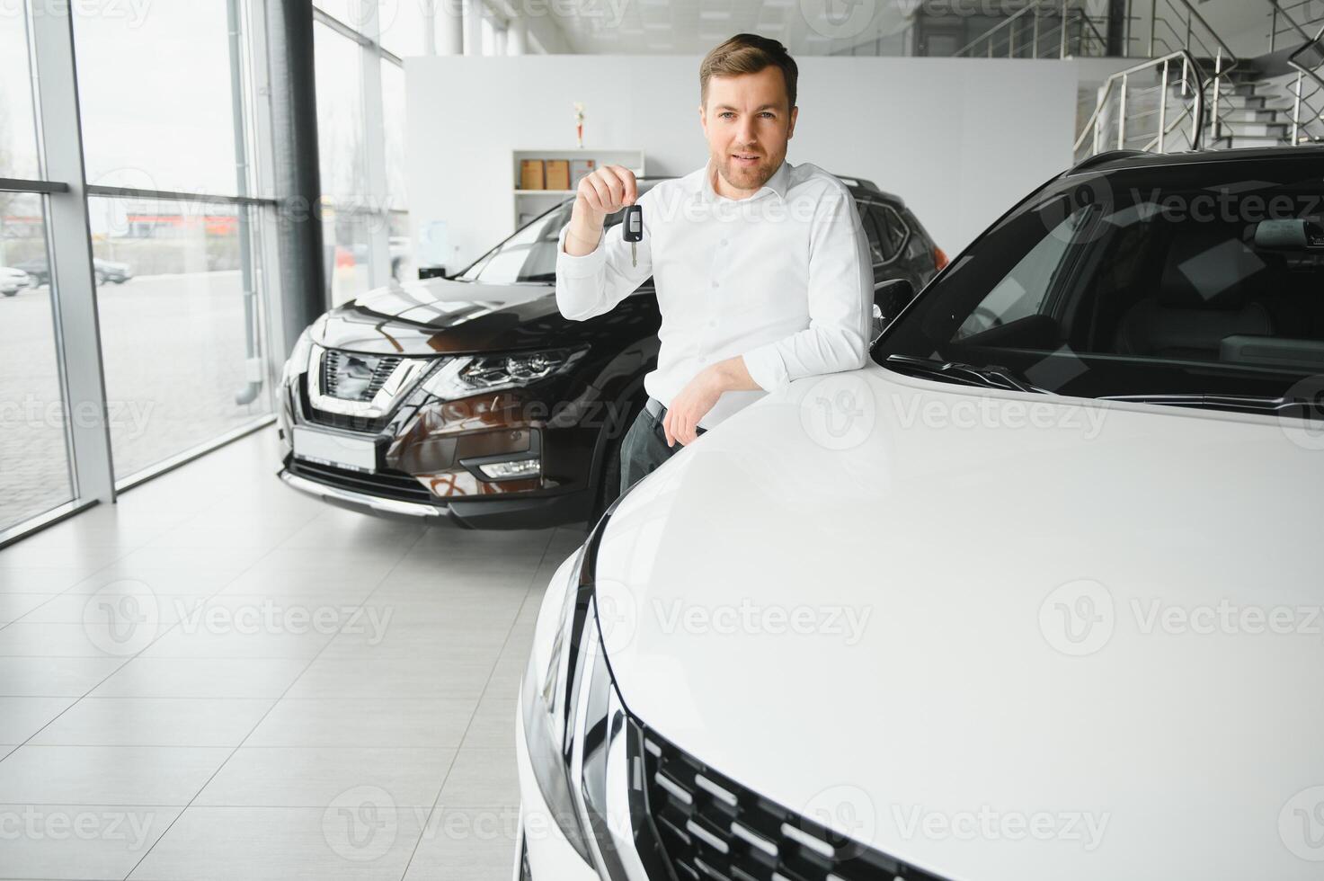 Happy customer just bought a car at car dealership photo