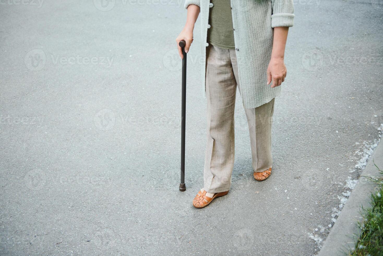 Woman with her walking stick in the park. photo