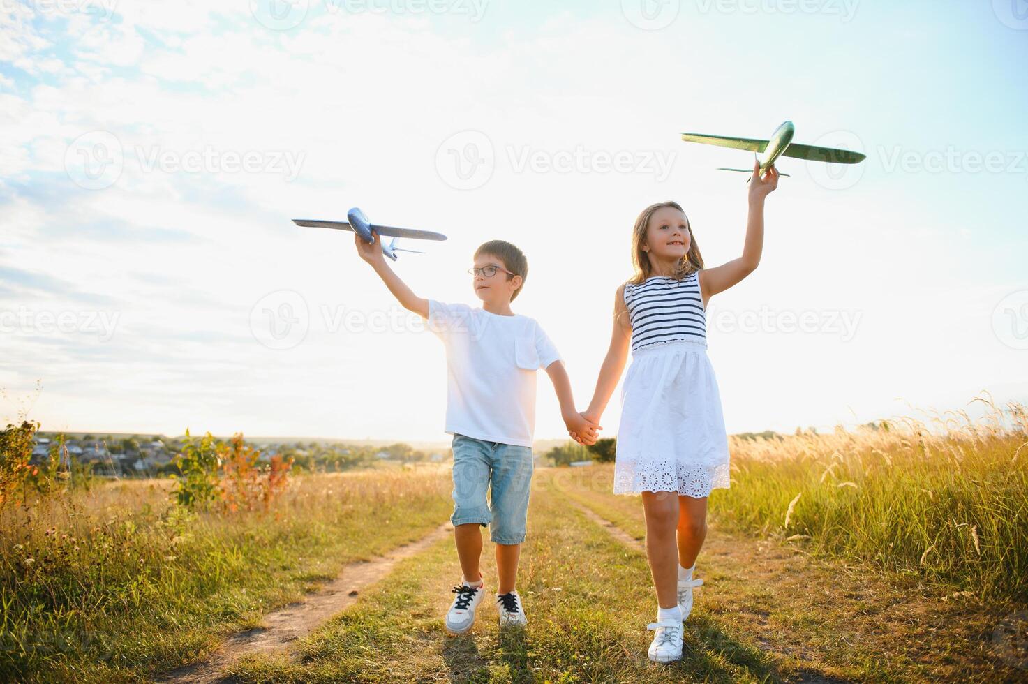 children play toy airplane. concept of happy childhood. children dream of flying and becoming a pilot. photo