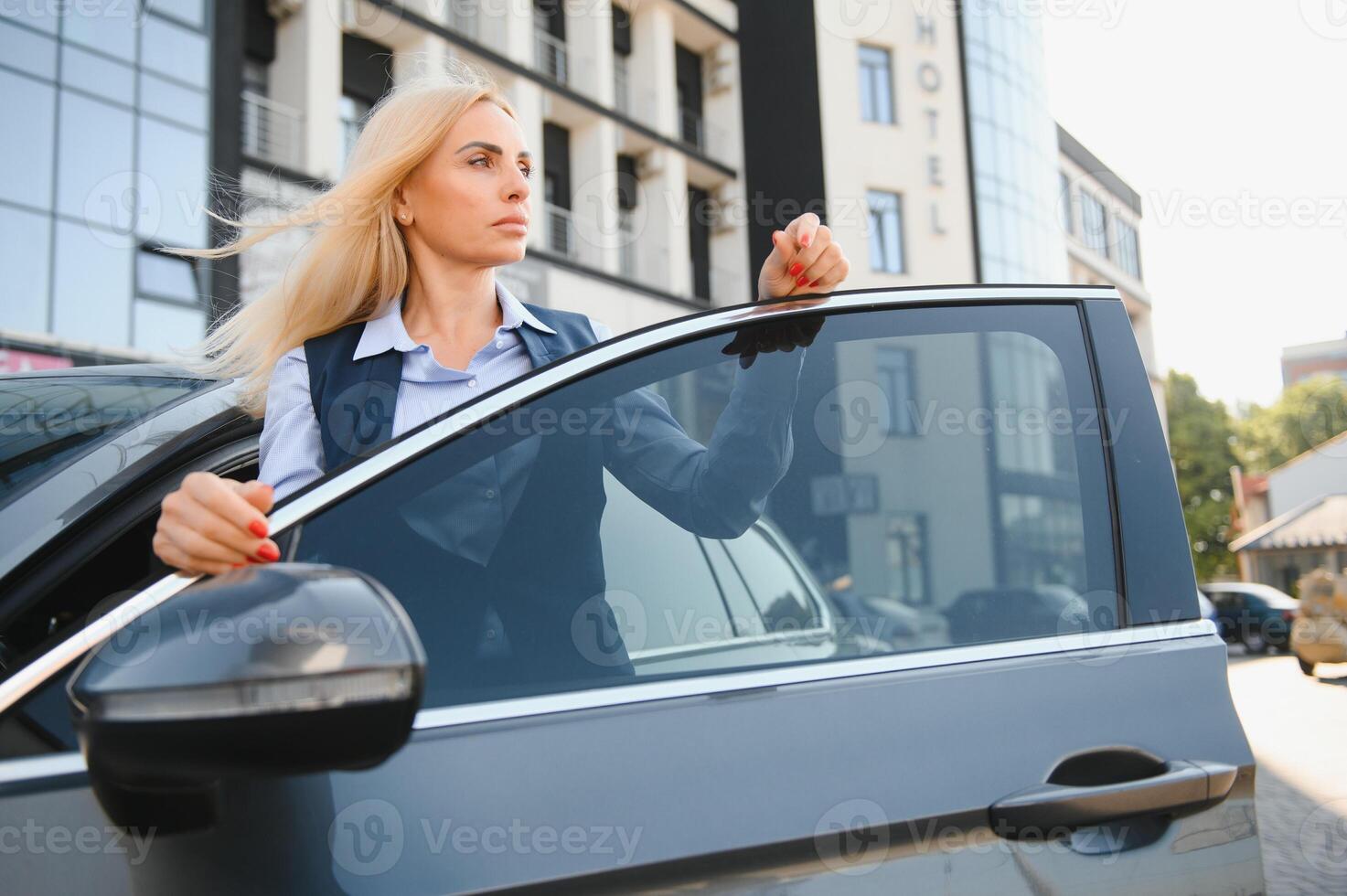 Nice business woman, standing near automobile. photo