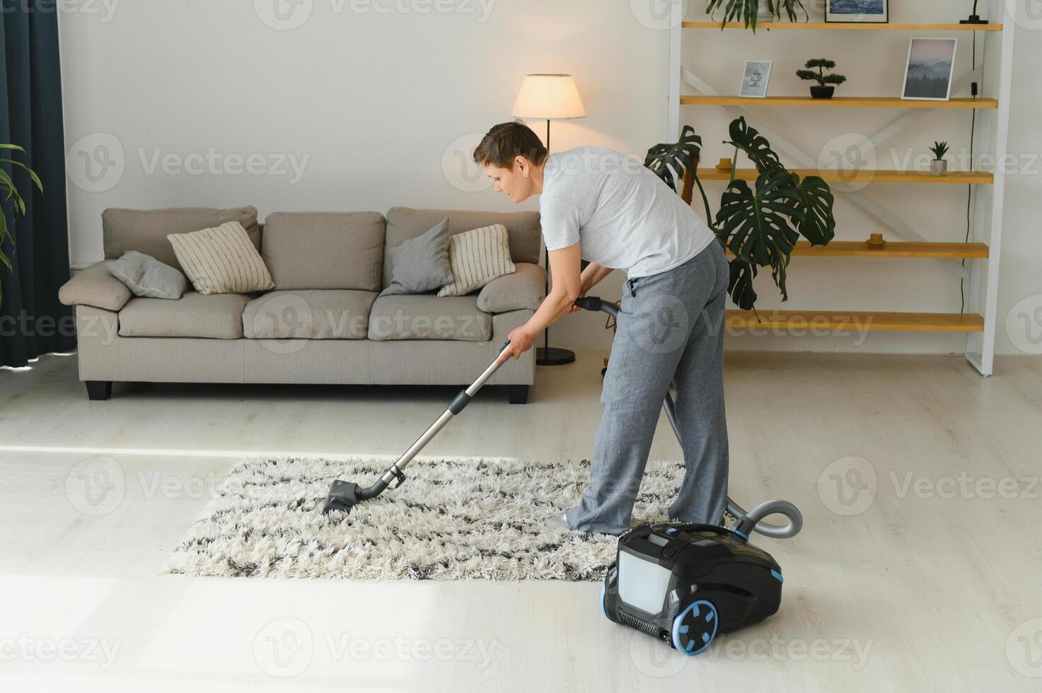 Middle-aged woman cleaning new apartment. photo