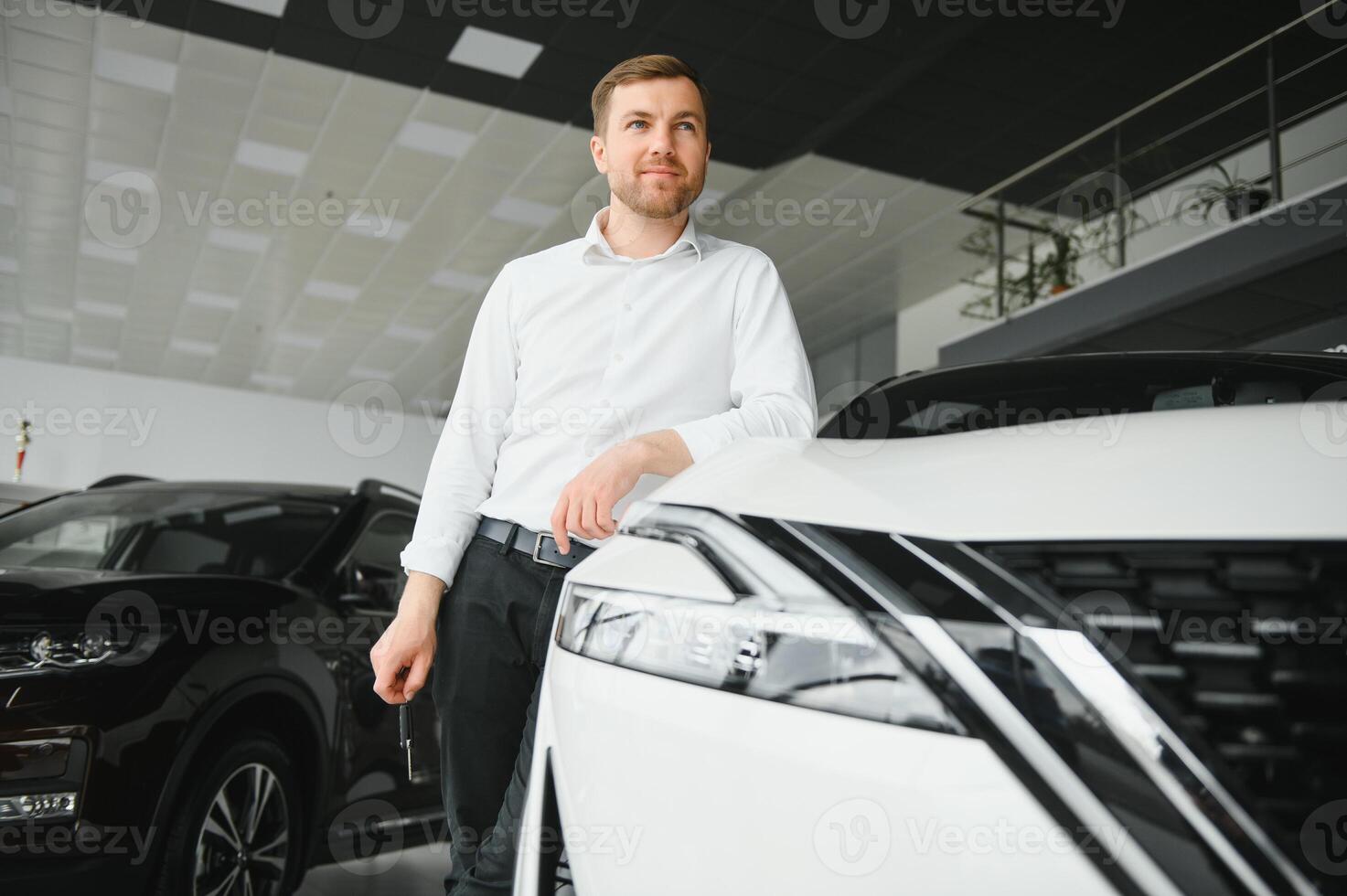 Happy customer just bought a car at car dealership photo