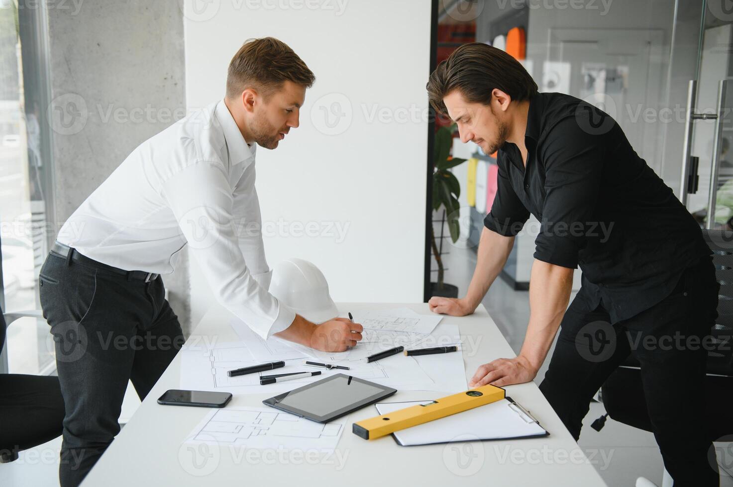 Engineer or architect teamwork working on construction project with building model and blueprint in office. Construction concept. photo