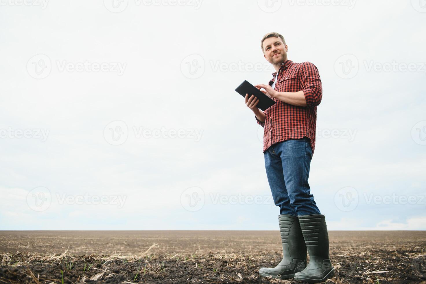 portrait of a young farmer in a field photo