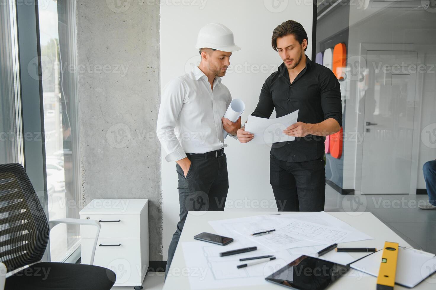 Engineer or architect teamwork working on construction project with building model and blueprint in office. Construction concept. photo