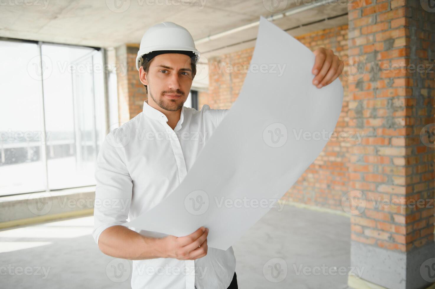 Close up engineers working on a building site holding a blueprints.Engineering and architecture concept photo