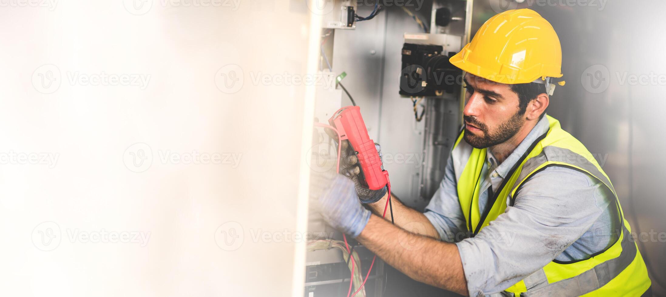 Electrical engineer work tester measuring voltage and current of power electric line in electrical cabinet control for industrial production. Panorama image use for cover design. photo