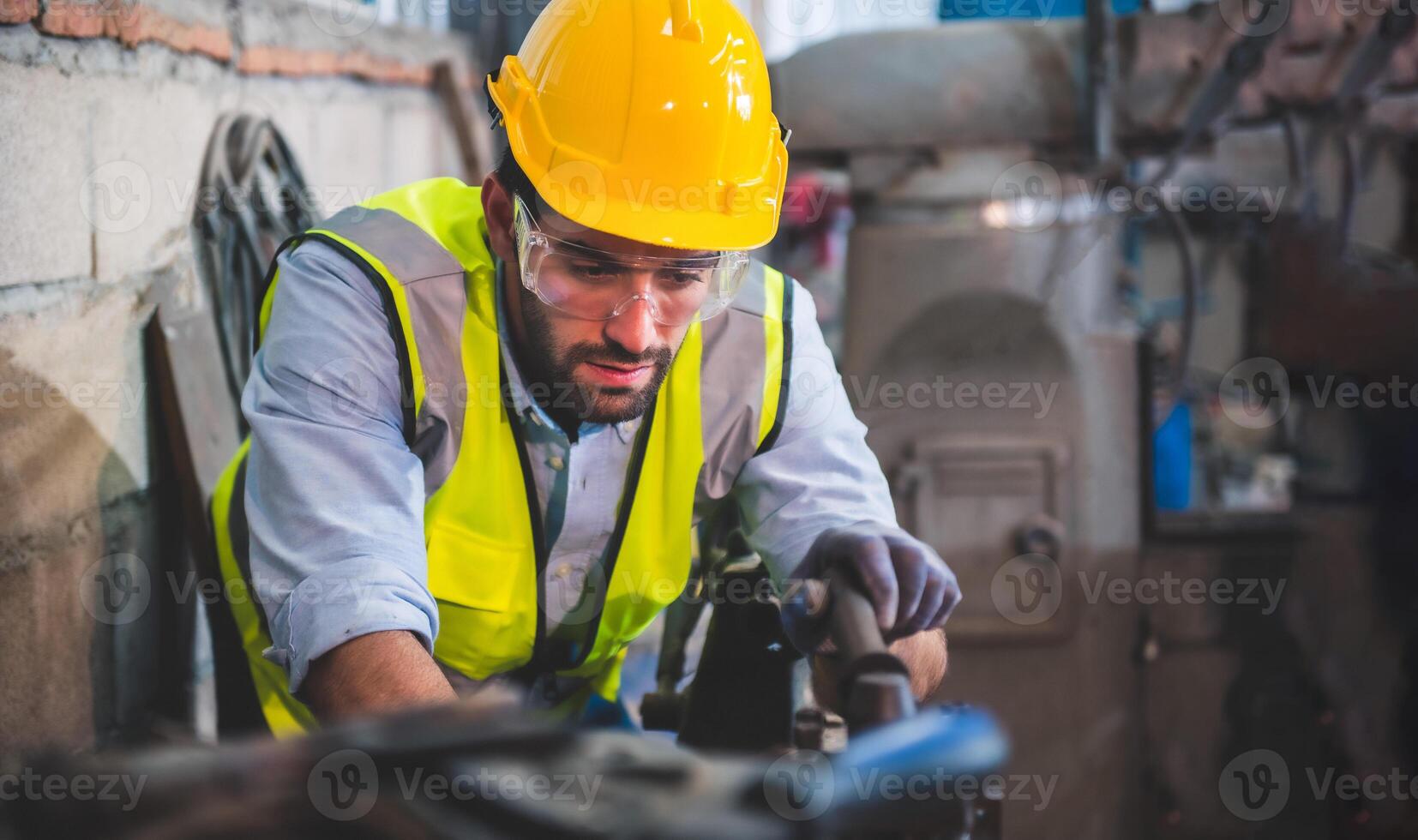 Portrait of Heavy industry workers working on the metal fabrication process by operating a lathe at a machine for steel structure industry. photo