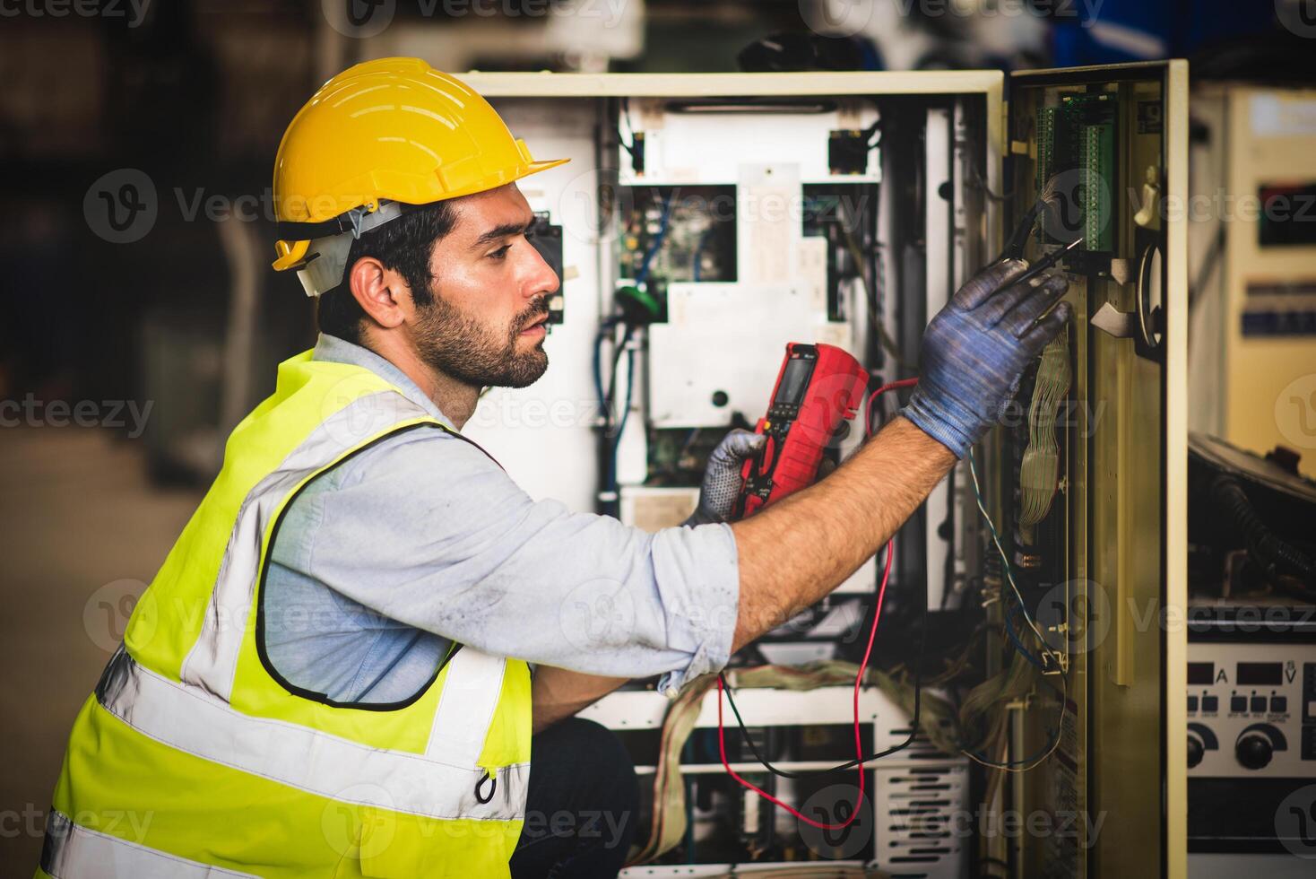 Electrical engineer work tester measuring voltage and current of power electric line in electrical cabinet control for industrial production. photo