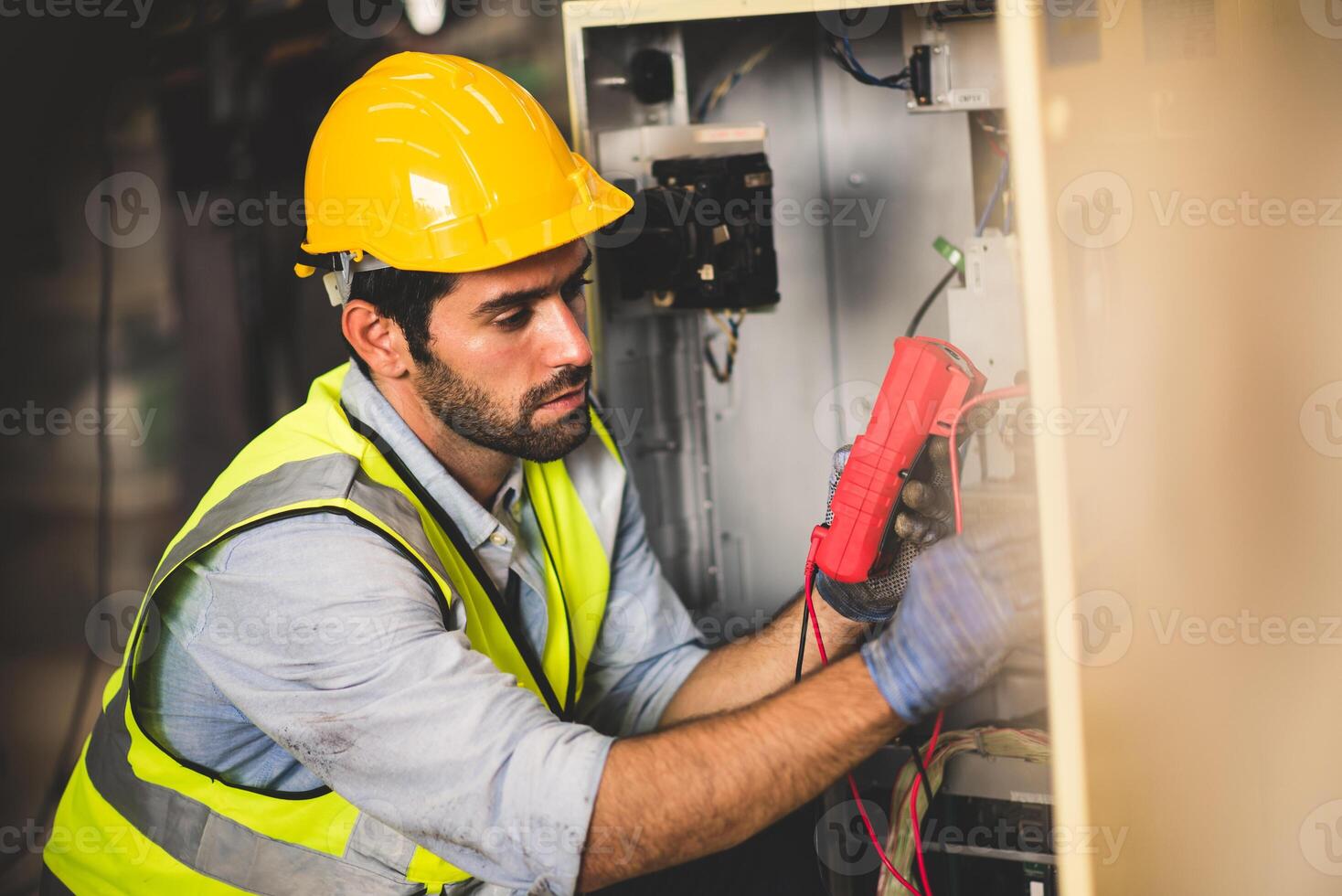 Electrical engineer work tester measuring voltage and current of power electric line in electrical cabinet control for industrial production. photo