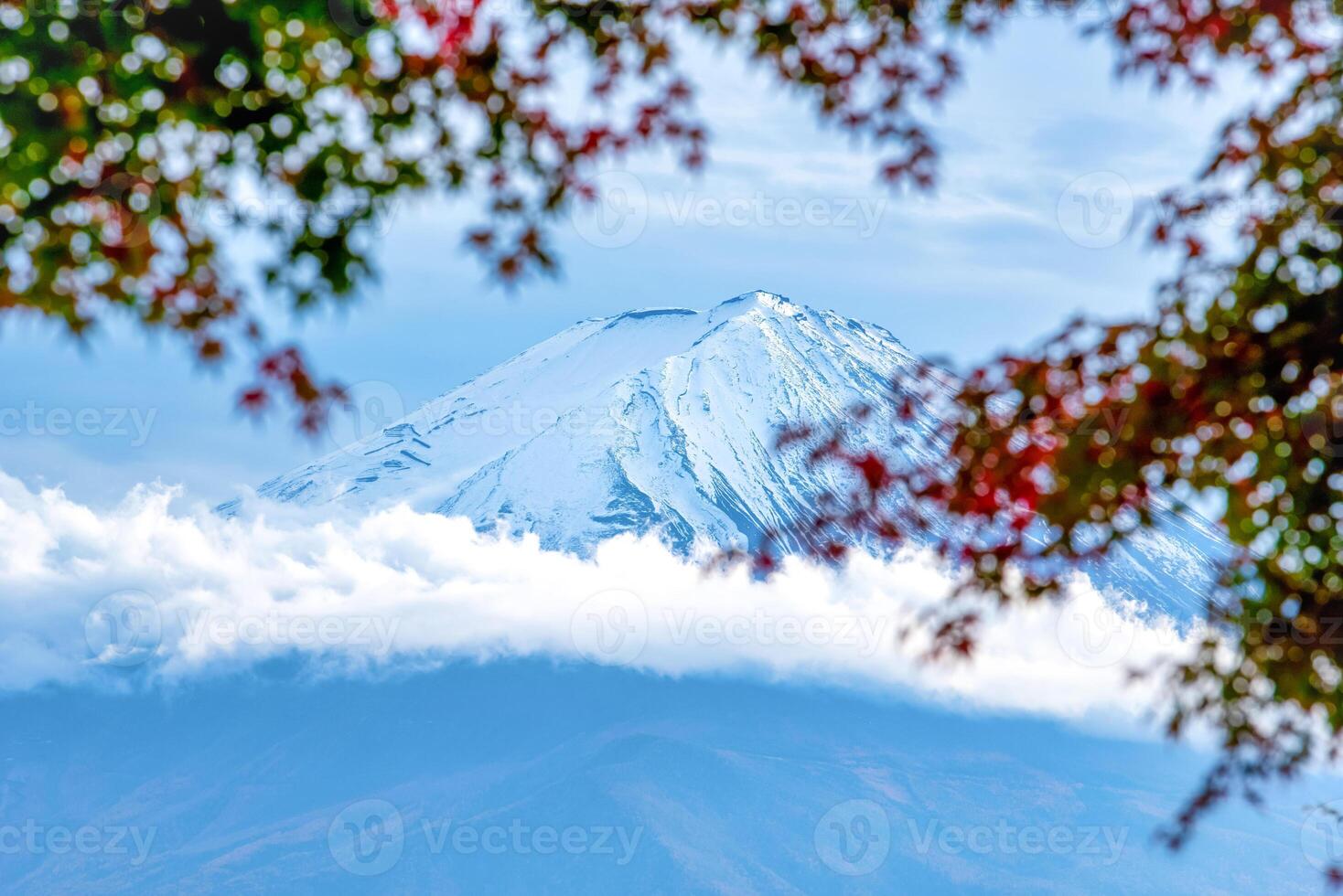 Mt. Fuji on blue sky background with autumn foliage at daytime in Fujikawaguchiko, Japan. photo