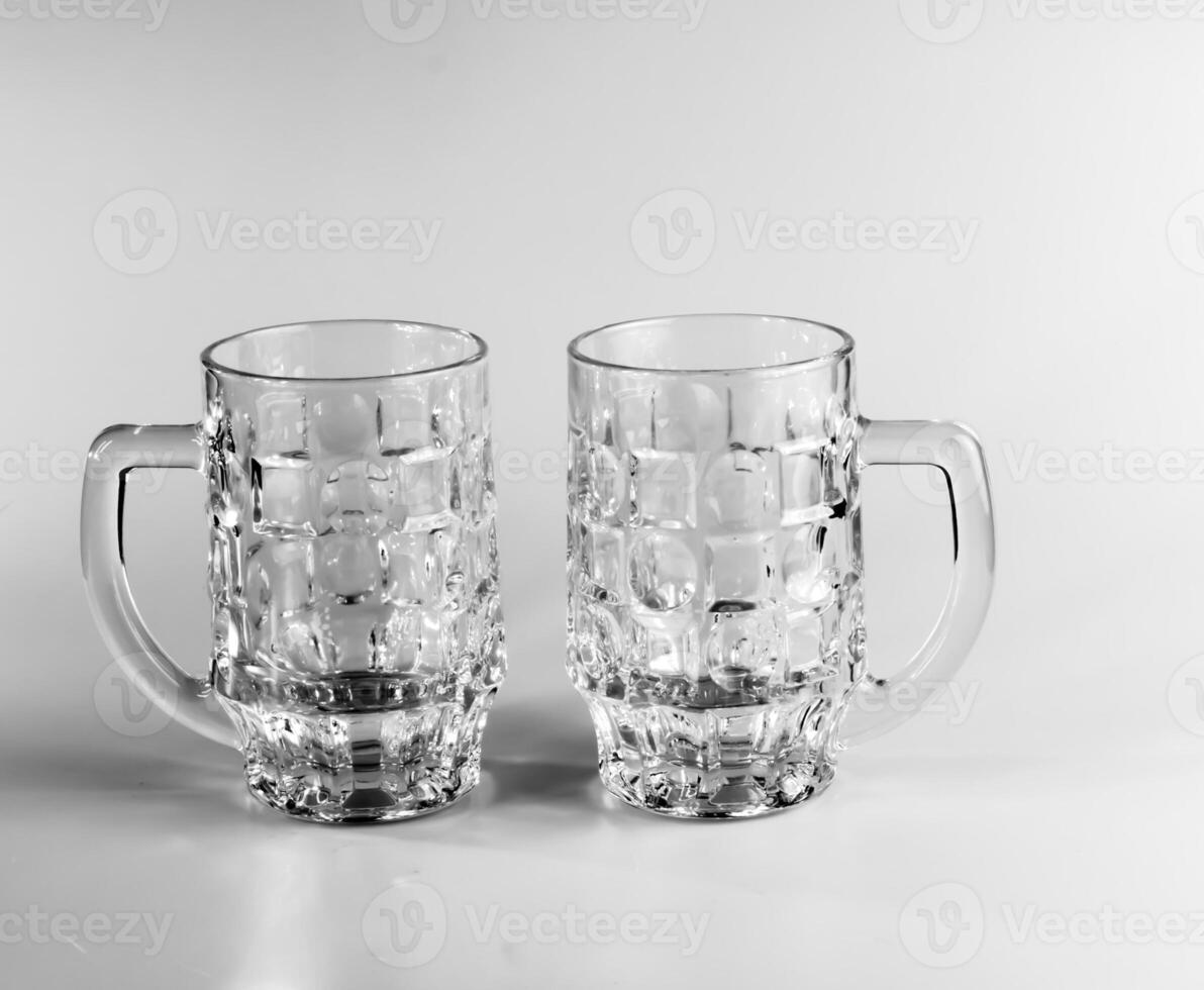 Two empty beer glasses on a white background. Crystal beer mugs. photo