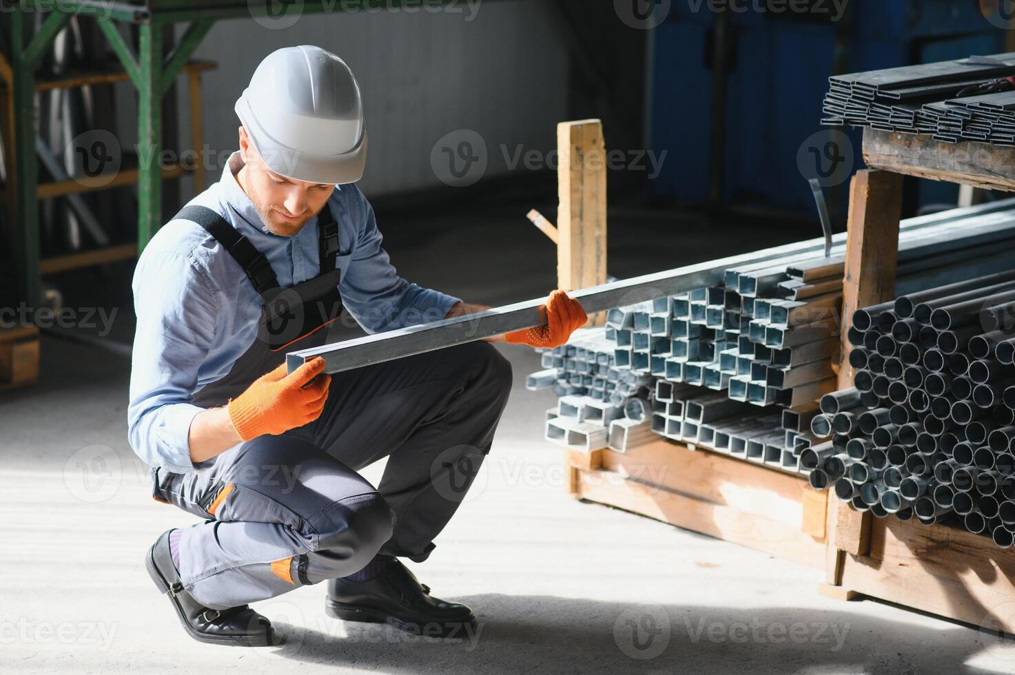 Profesional fabric worker. Metal processing plant. A worker at a metal profile warehouse. photo