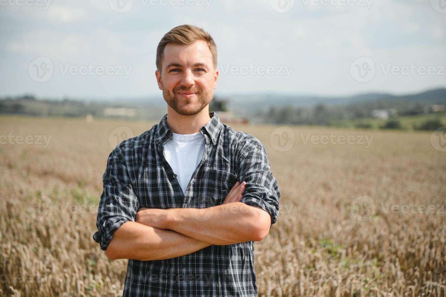 Farmer Standing In Wheat Field At Harvest. photo