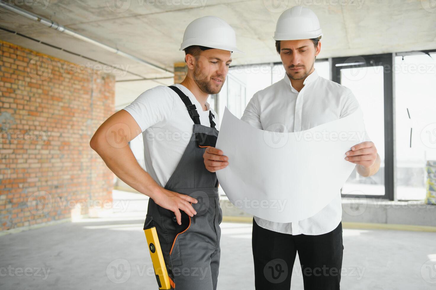 Construction concept of Engineer and Architect working at Construction Site with blue print. photo