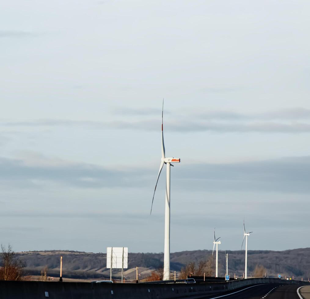 Wind farm park next to a road in Austria in sunny weather. photo