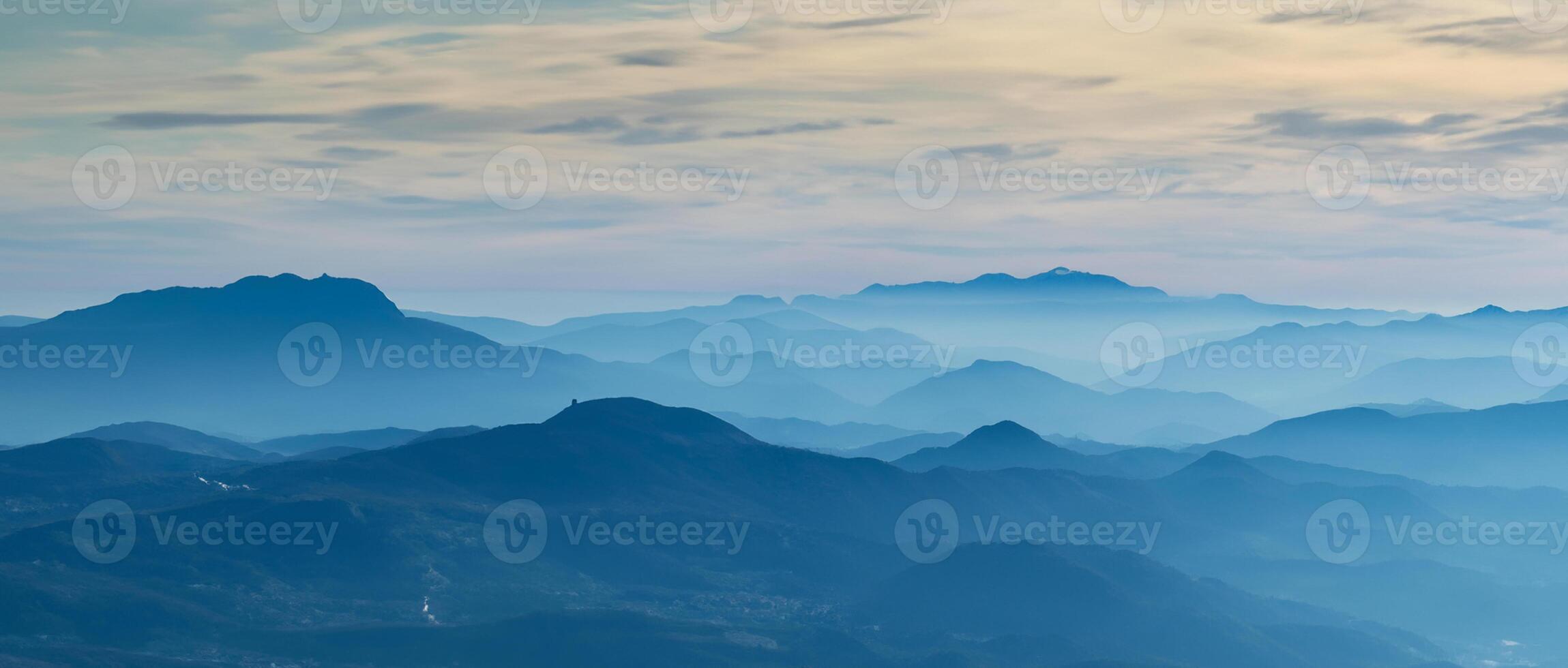 Amazing drone aerial landscape at the Italian Alps in winter and autumn. Morning panorama. Fall sunrise at the alps with moisture and pollution in the air. Silhouette of the mountains and hills photo