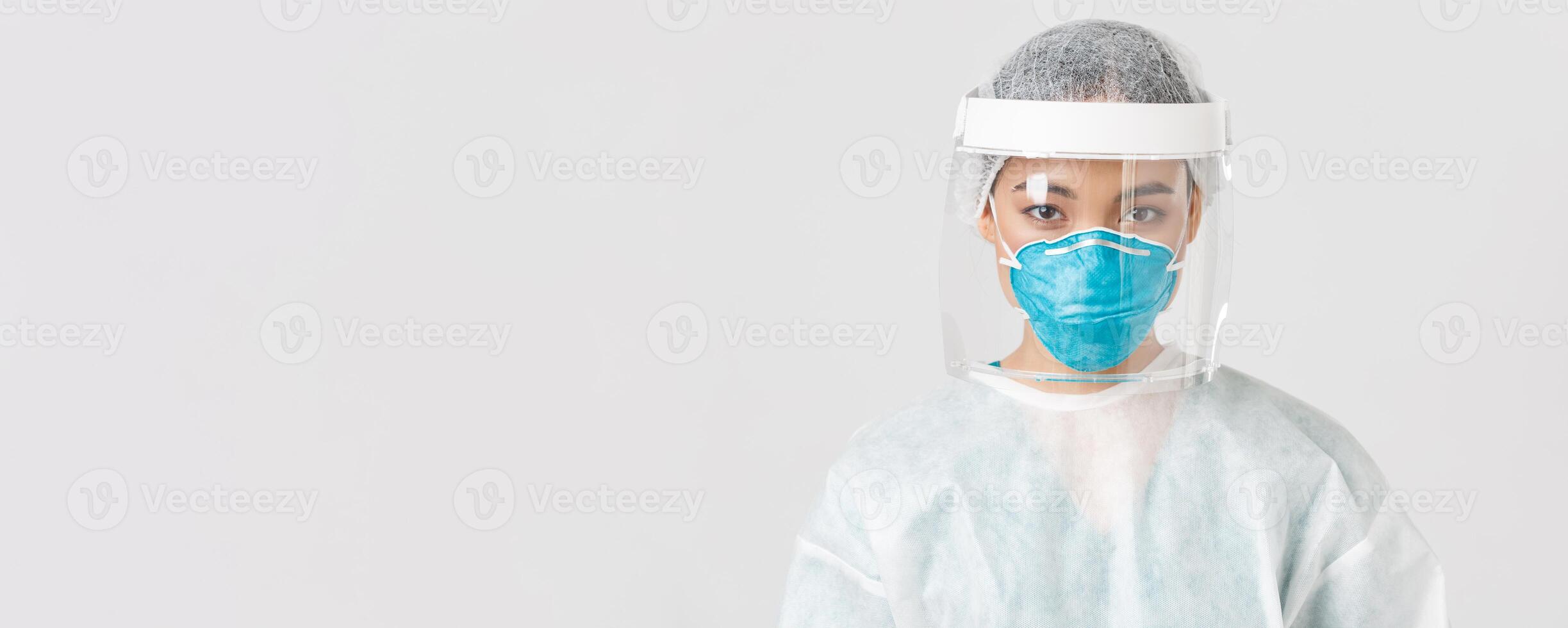 Covid-19, coronavirus disease, healthcare workers concept. Close-up of confident serious-looking female tech lab employee, doctor in personal protective equipment, respirator and face shield photo