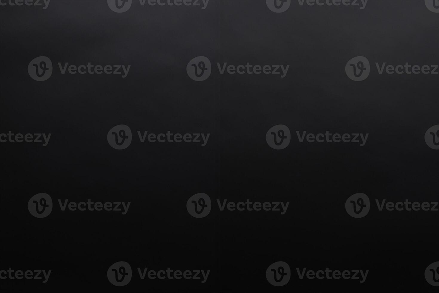 Dark gray texture background with a little light spil photo