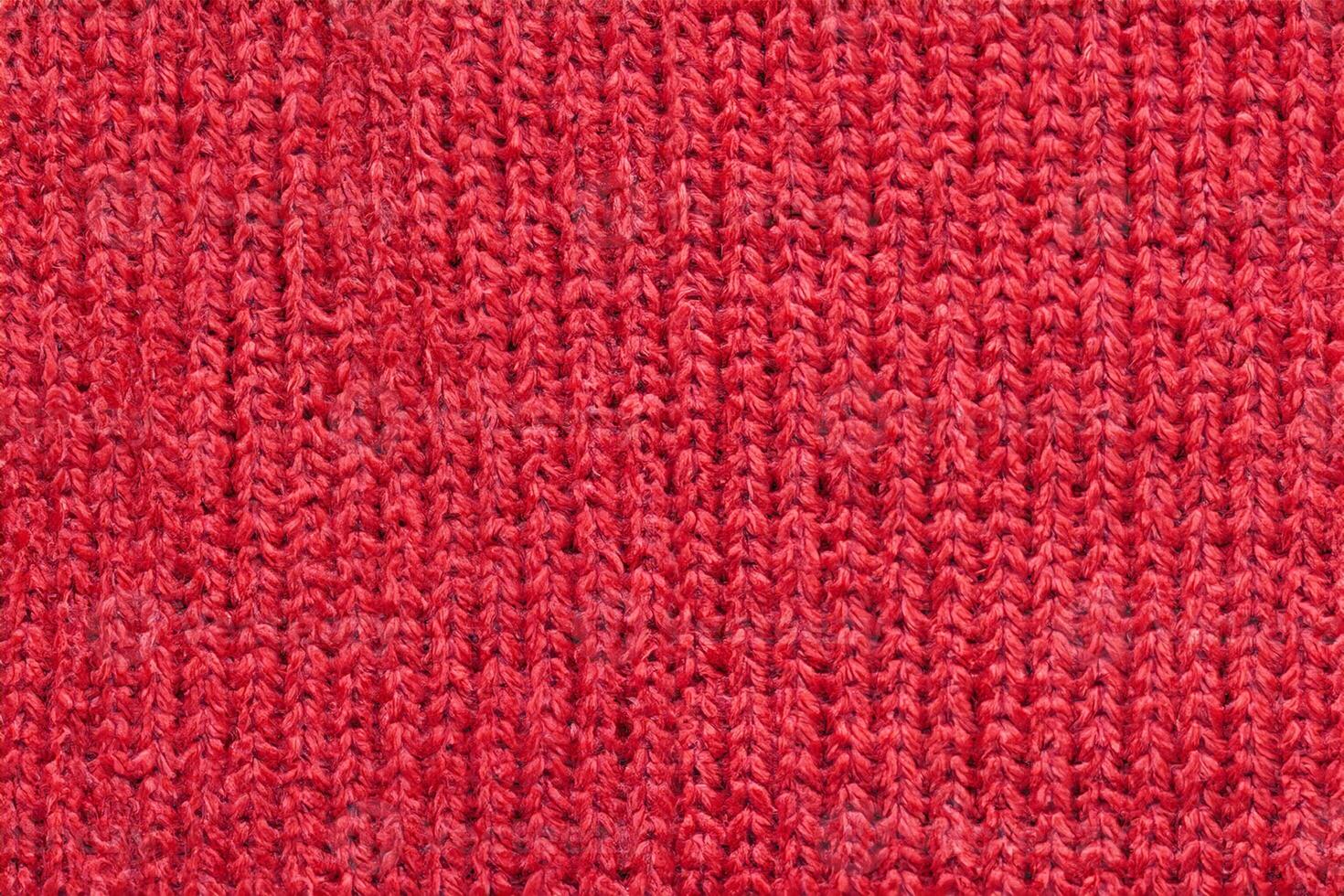 Red knitted wool fabric texture background photo