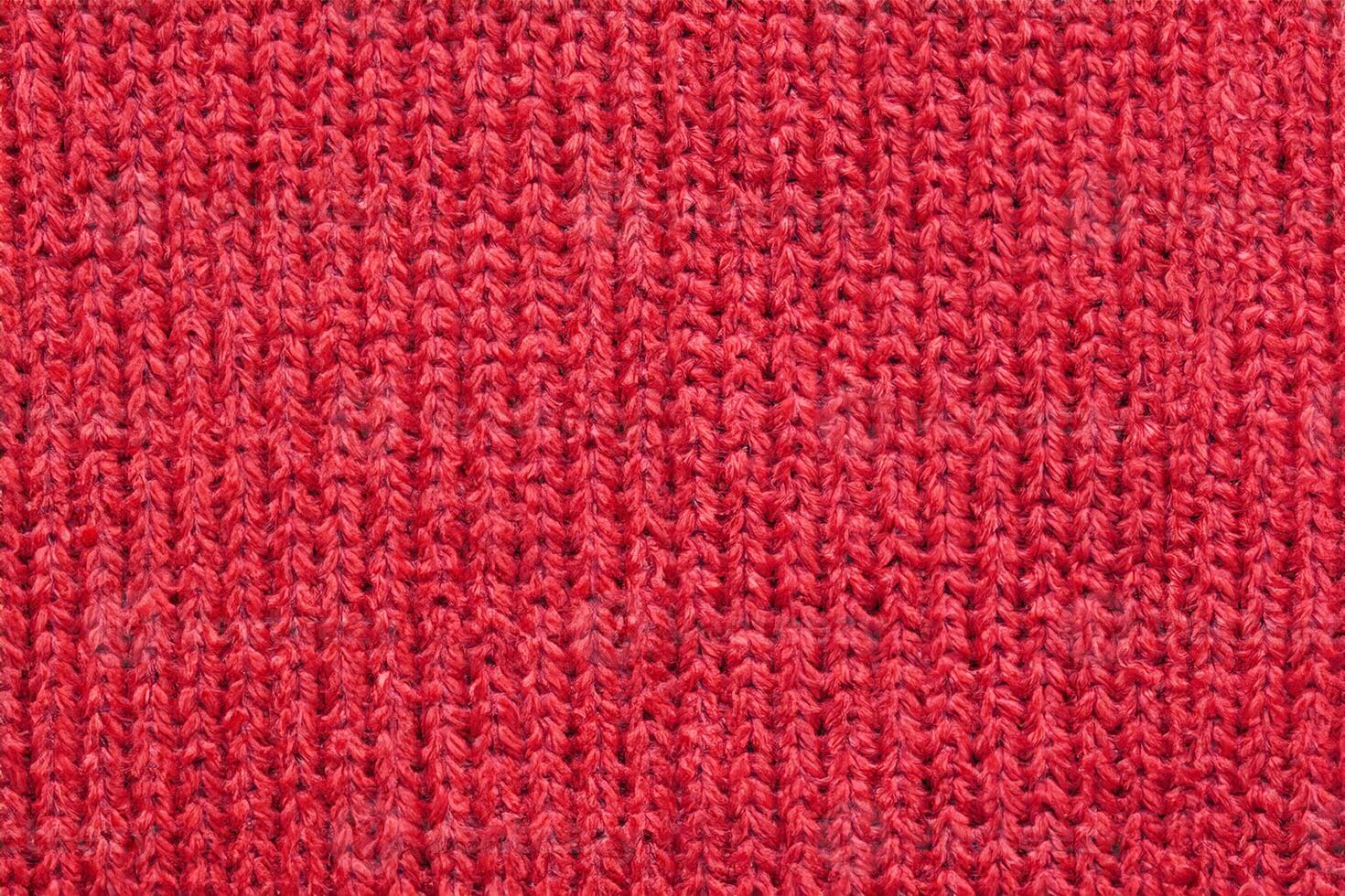 Red knitted wool fabric texture background photo