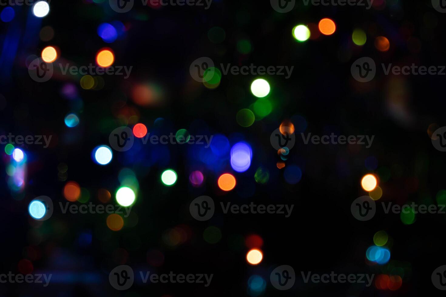 Colorful multicolored defocused bokeh lights on a blurred night background photo