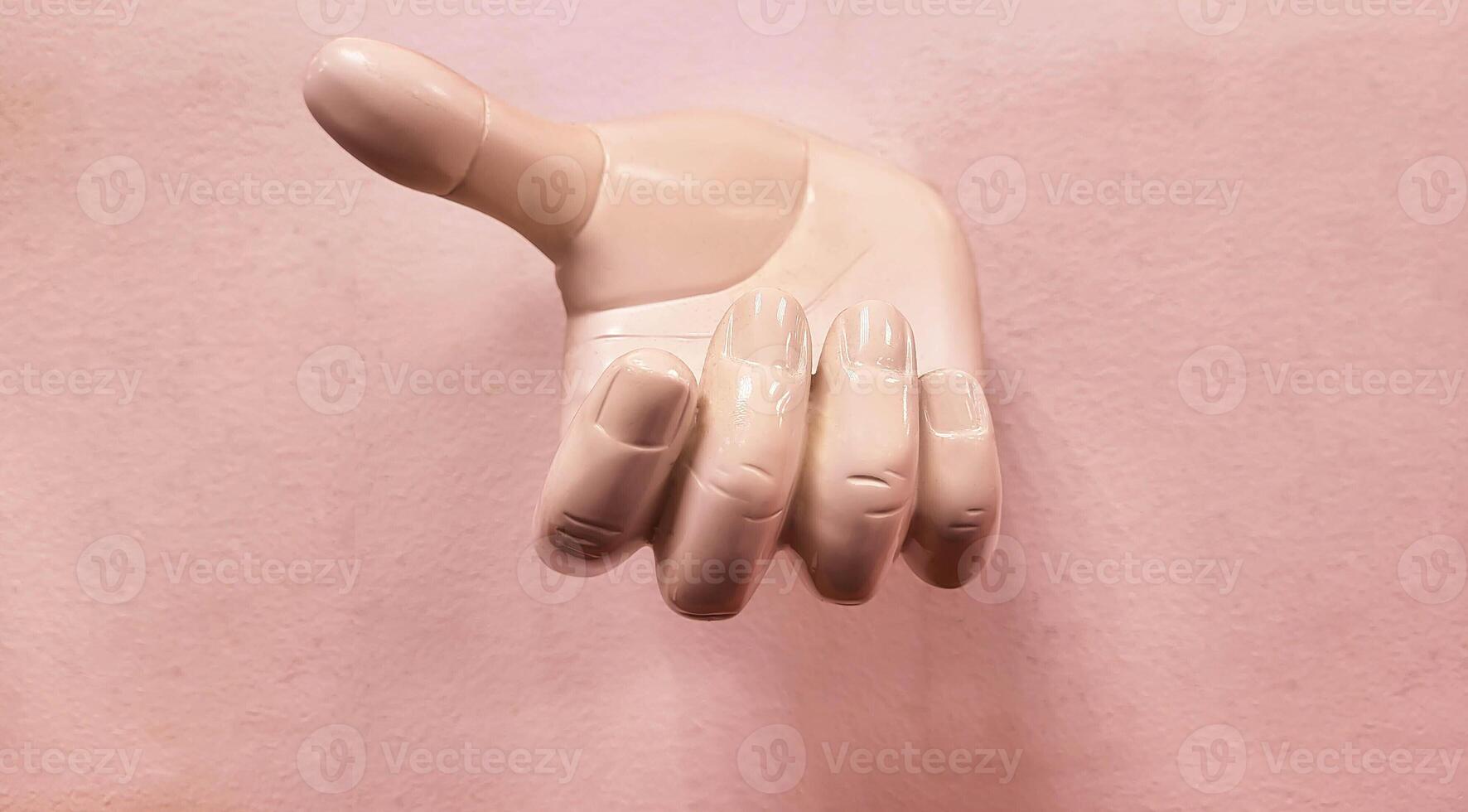 A plaster limb, the color of peach fuzz. Hand with fingers, body part photo