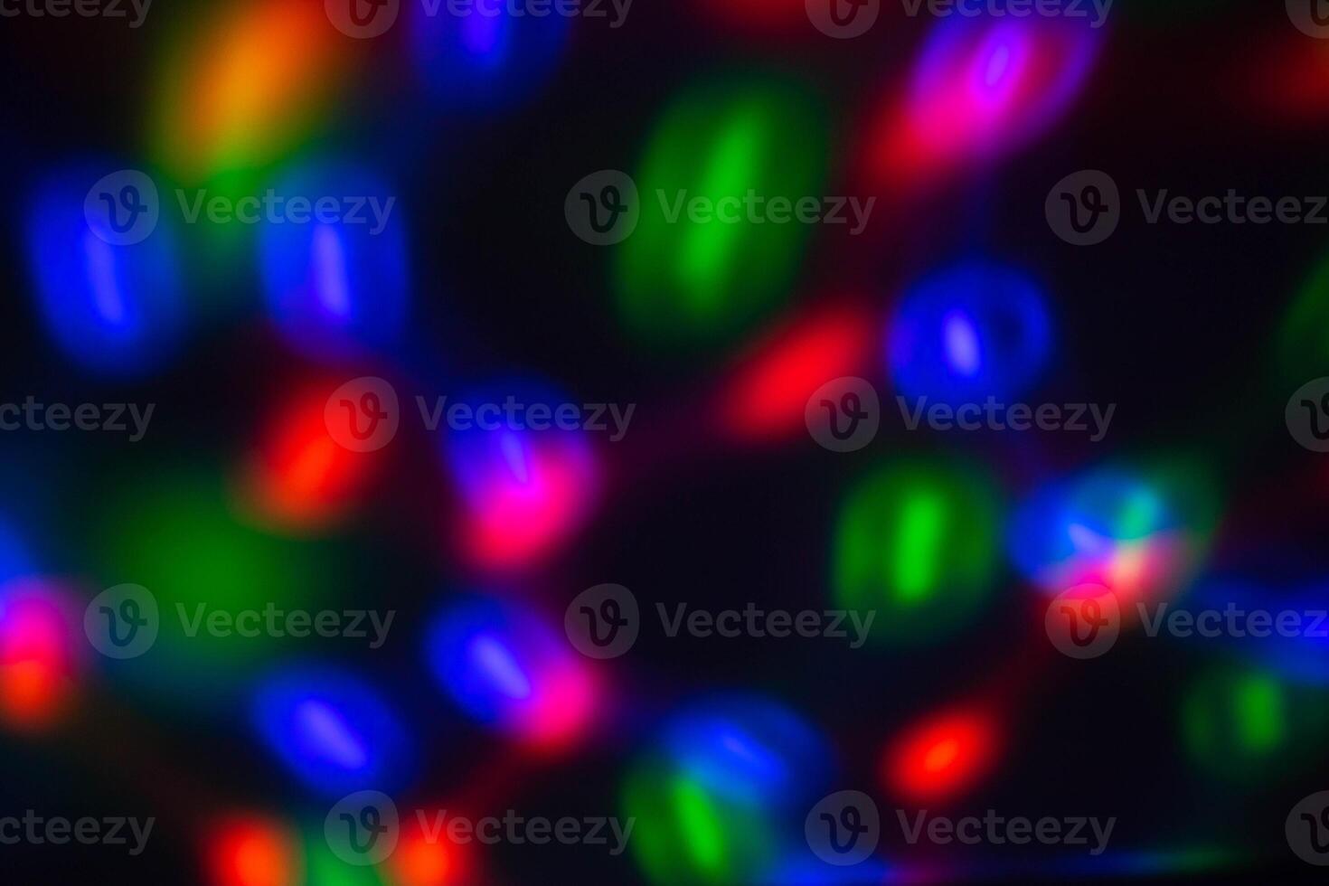Colorful multicolored defocused bokeh lights on a blurred night background photo
