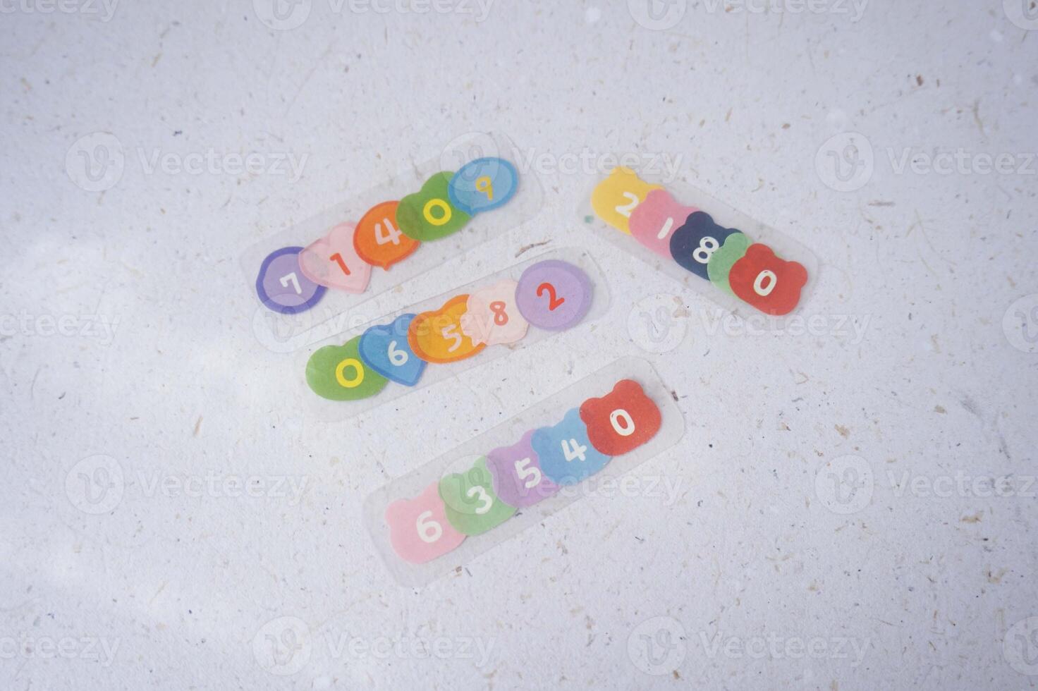 Colorful plastic alphabet on white paper background with space for text. photo