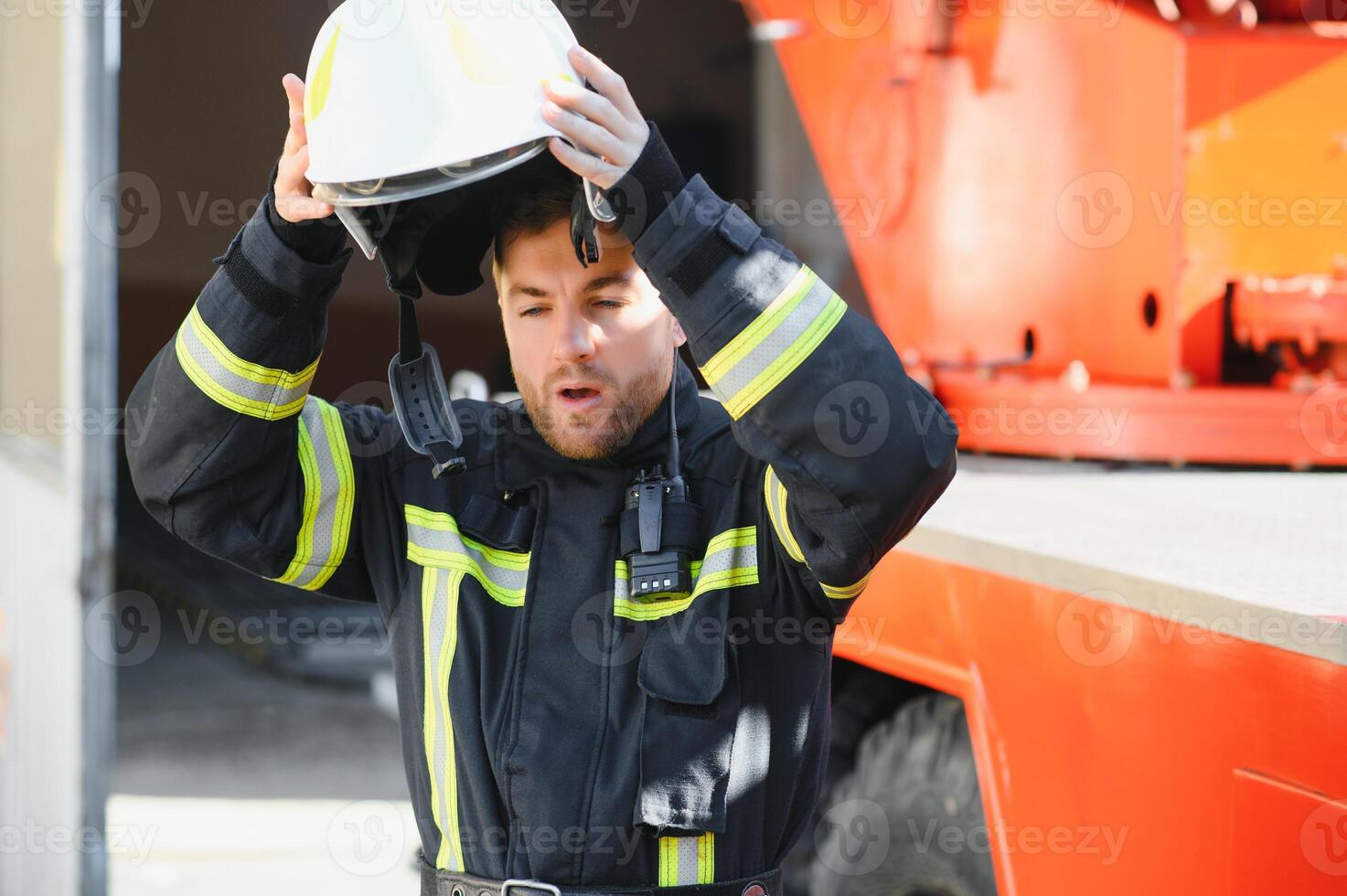 Photo of fireman with gas mask and helmet near fire engine