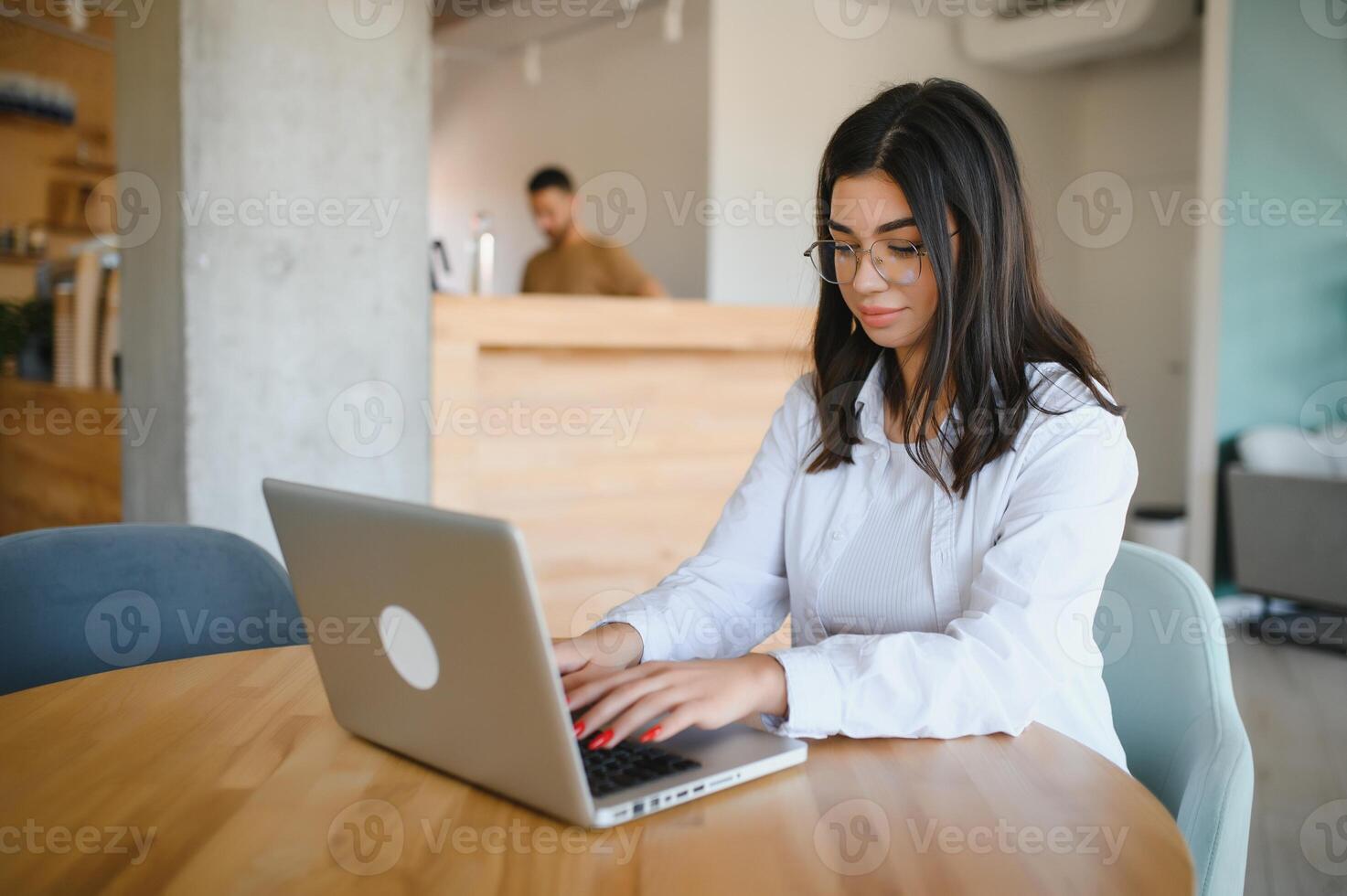 Beautiful Caucasian woman dreaming about something while sitting with portable net-book in modern cafe bar, young charming female freelancer thinking about new ideas during work on laptop computer photo