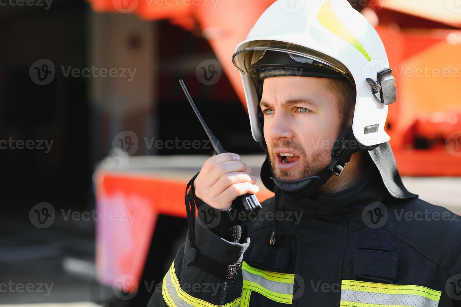 Photo of fireman with gas mask and helmet near fire engine