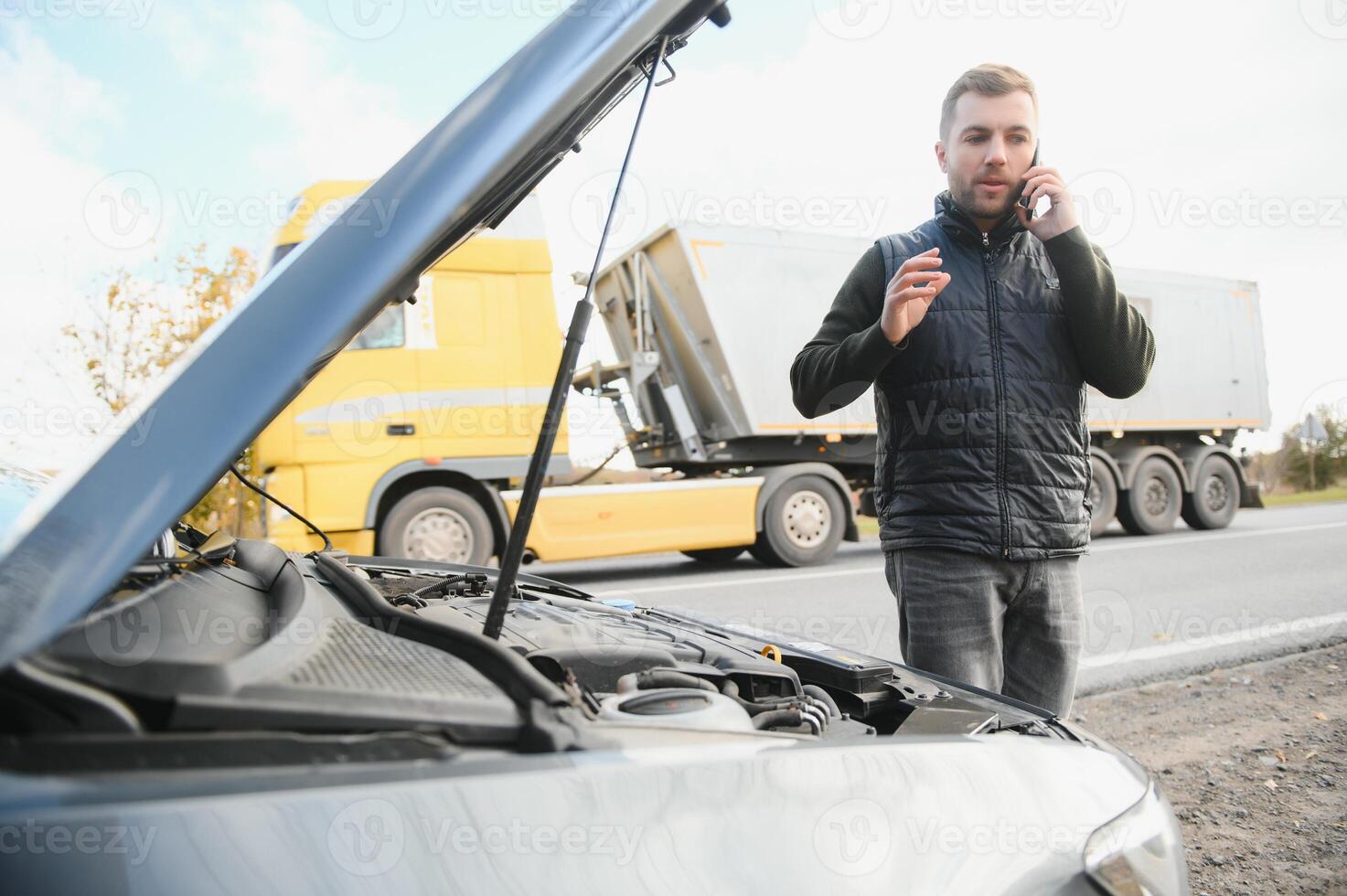 car broke down on the road, a man calls the emergency service, a tow truck. photo