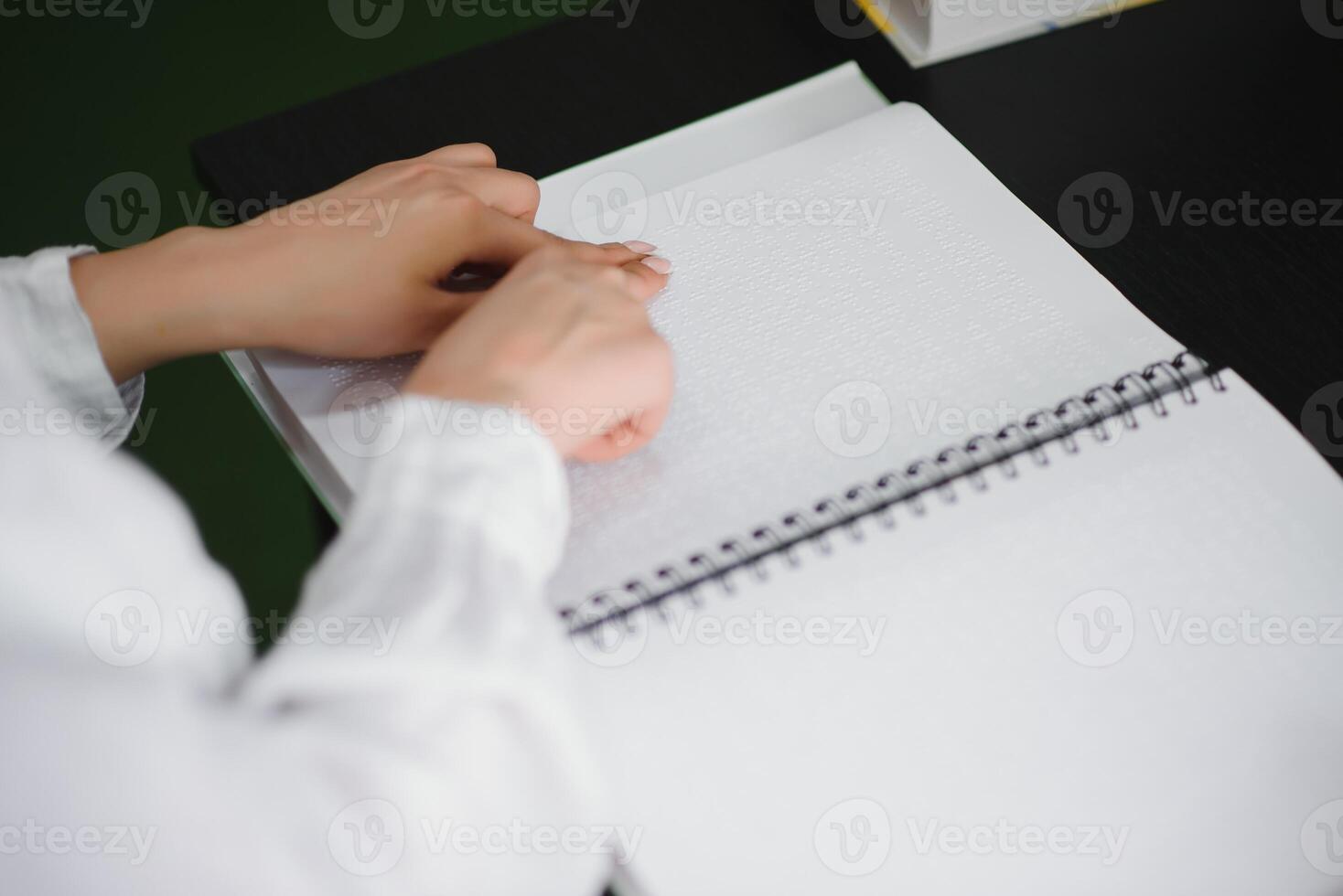 Blind woman read book written in Braille photo