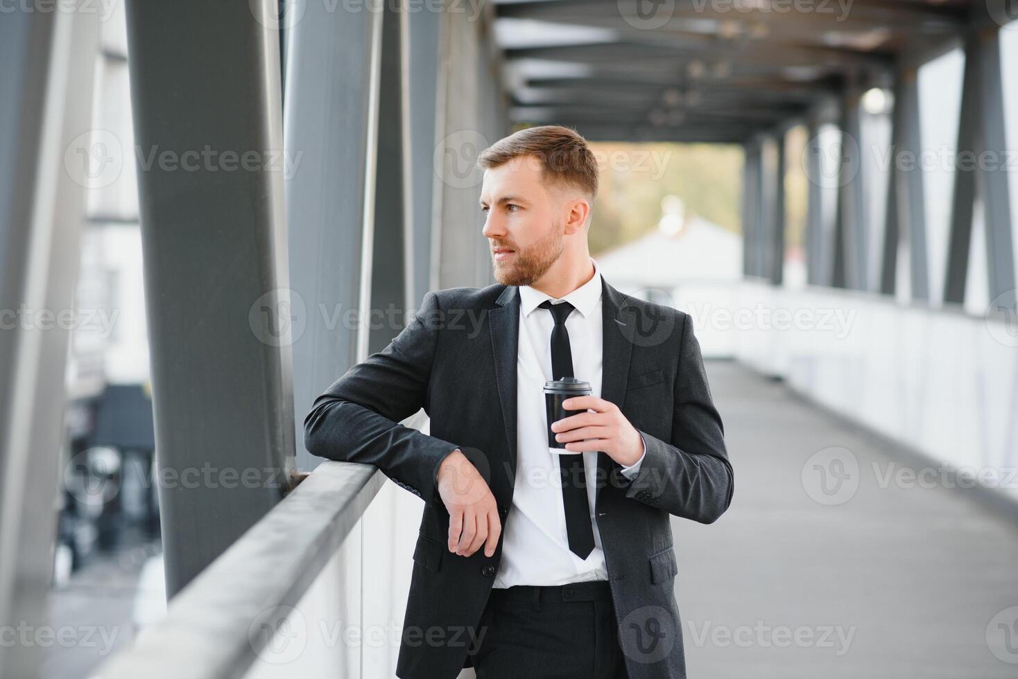 Takeaway coffee. Walk and enjoy fresh hot coffee. Waiting for someone in street. Man bearded hipster drink coffee paper cup. Businessman well groomed enjoy coffee break outdoors urban background photo