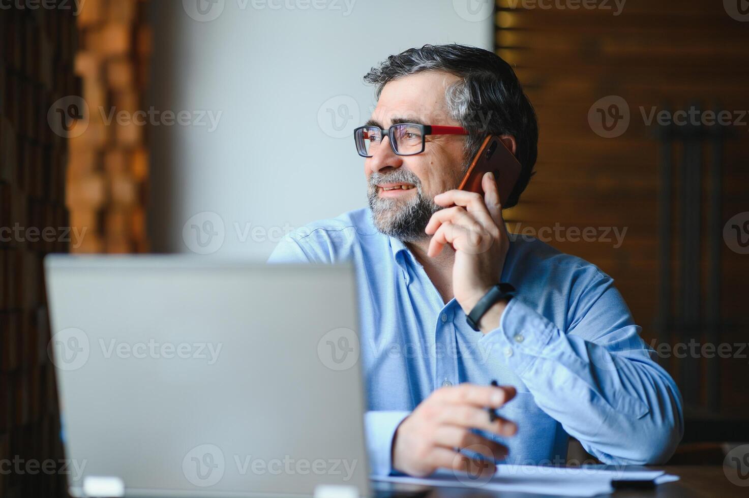 Business, technology and people concept , senior businessman with laptop computer drinking coffee at modern cafe. photo