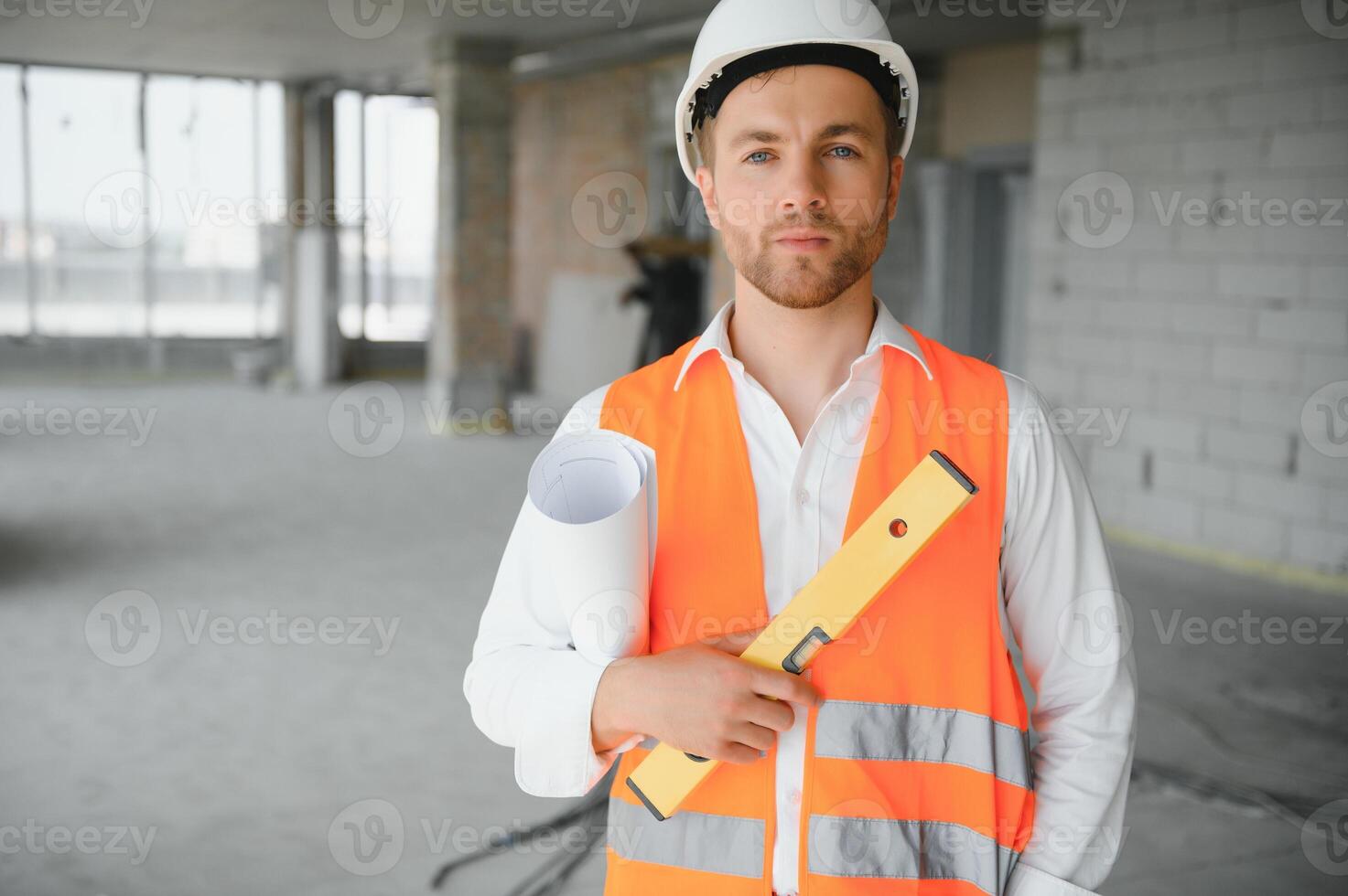 Close up engineers working on a building site holding a blueprints.Engineering and architecture concept photo