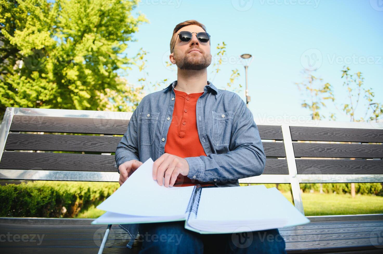 Blinded man reading by touching braille book photo