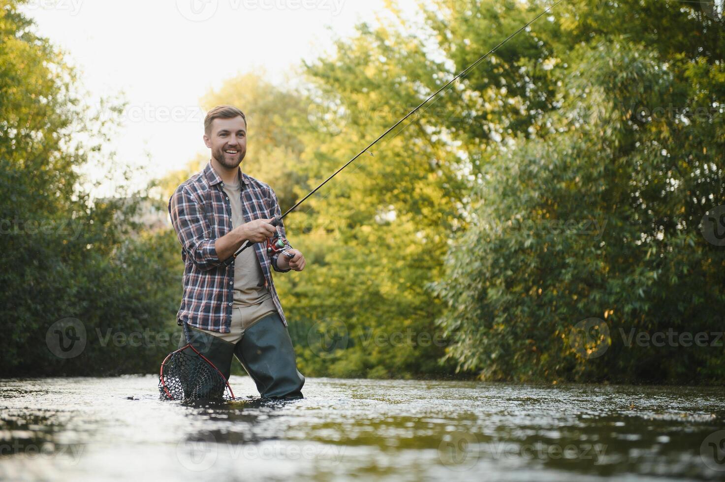 Trout fishing on mountain river photo