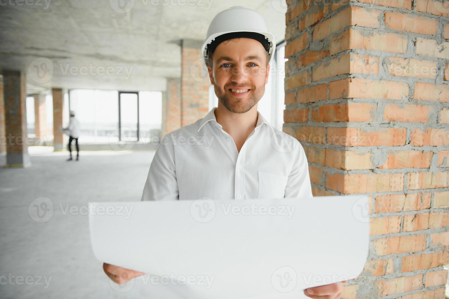 Close up engineers working on a building site holding a blueprints.Engineering and architecture concept photo