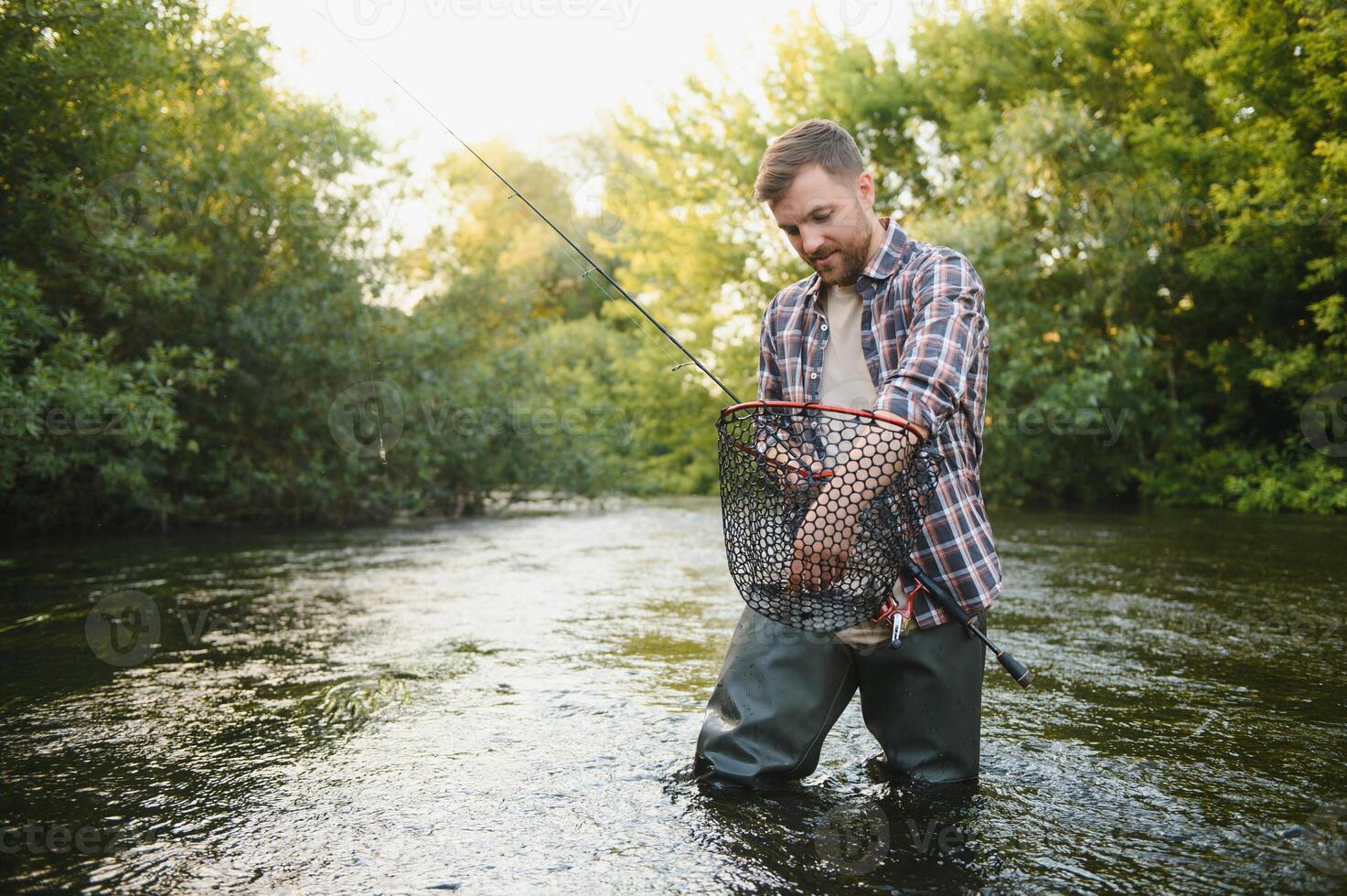 trout being caught in fishing net. photo