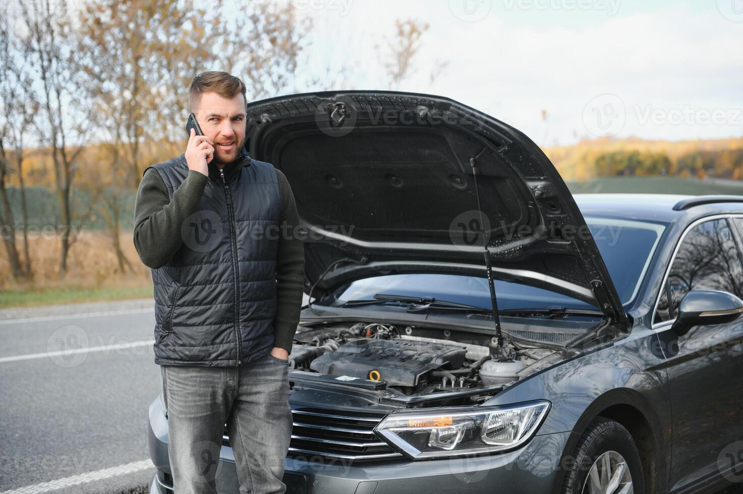 The car broke down, smokes from under the hood, the driver shocked photo